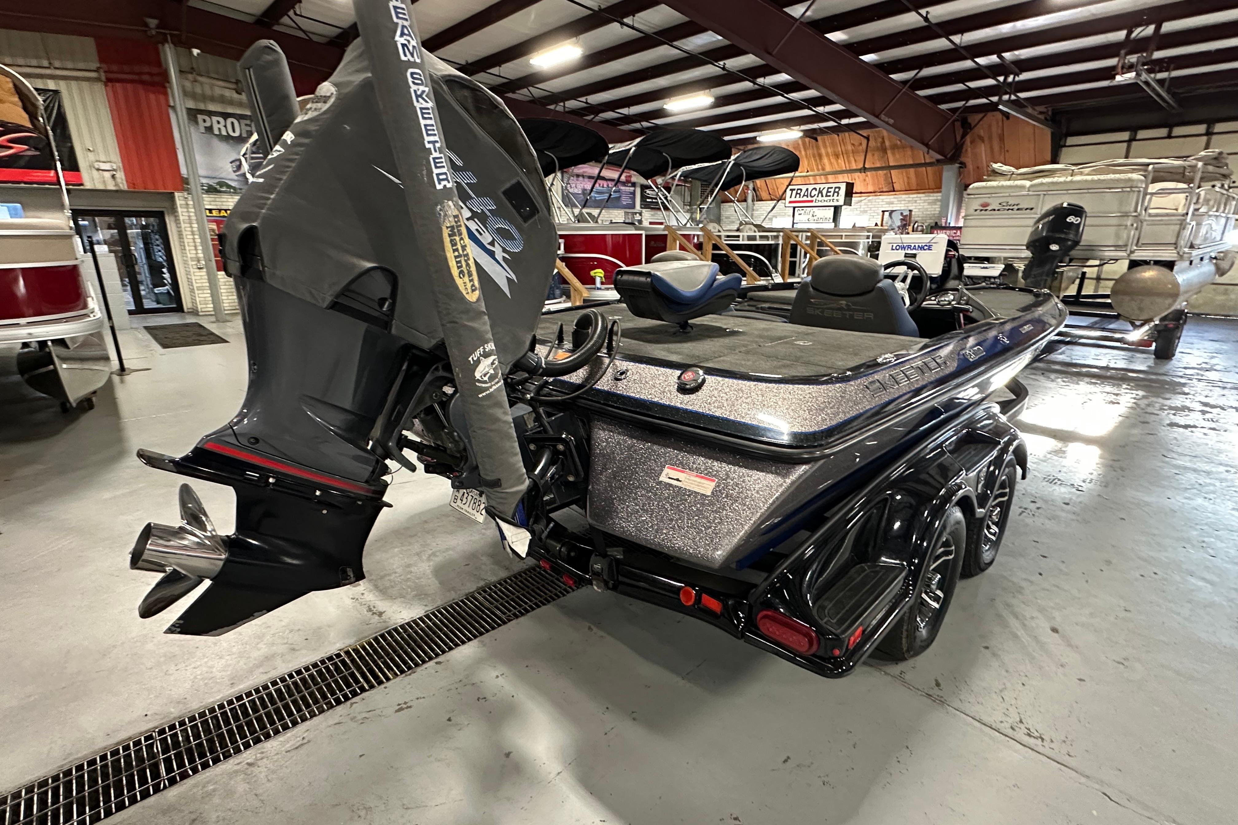 2016 Skeeter FX20 Limited Edition boat in showroom, featuring powerful outboard motor.
