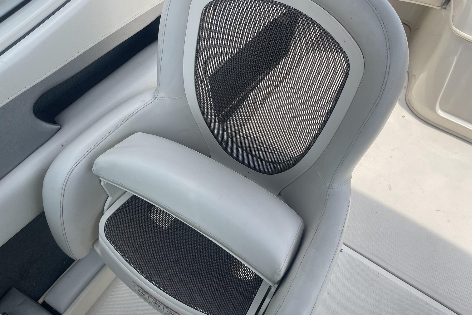 2010 Sea Ray 230 Bow Rider Select boat seat with mesh backrest and white upholstery.