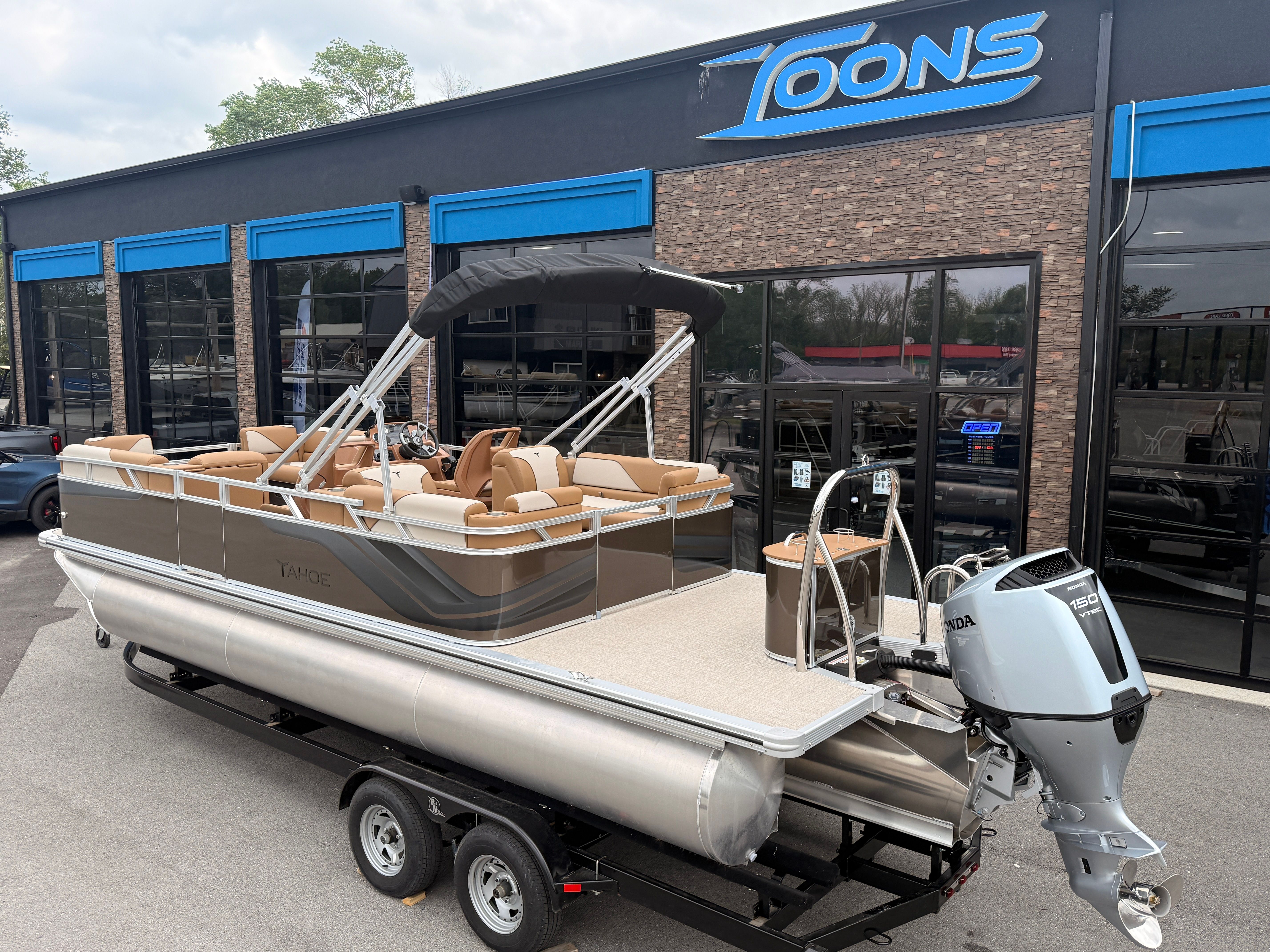 2026 Tahoe 2380 Sport Quad Lounger pontoon boat outside a dealership.