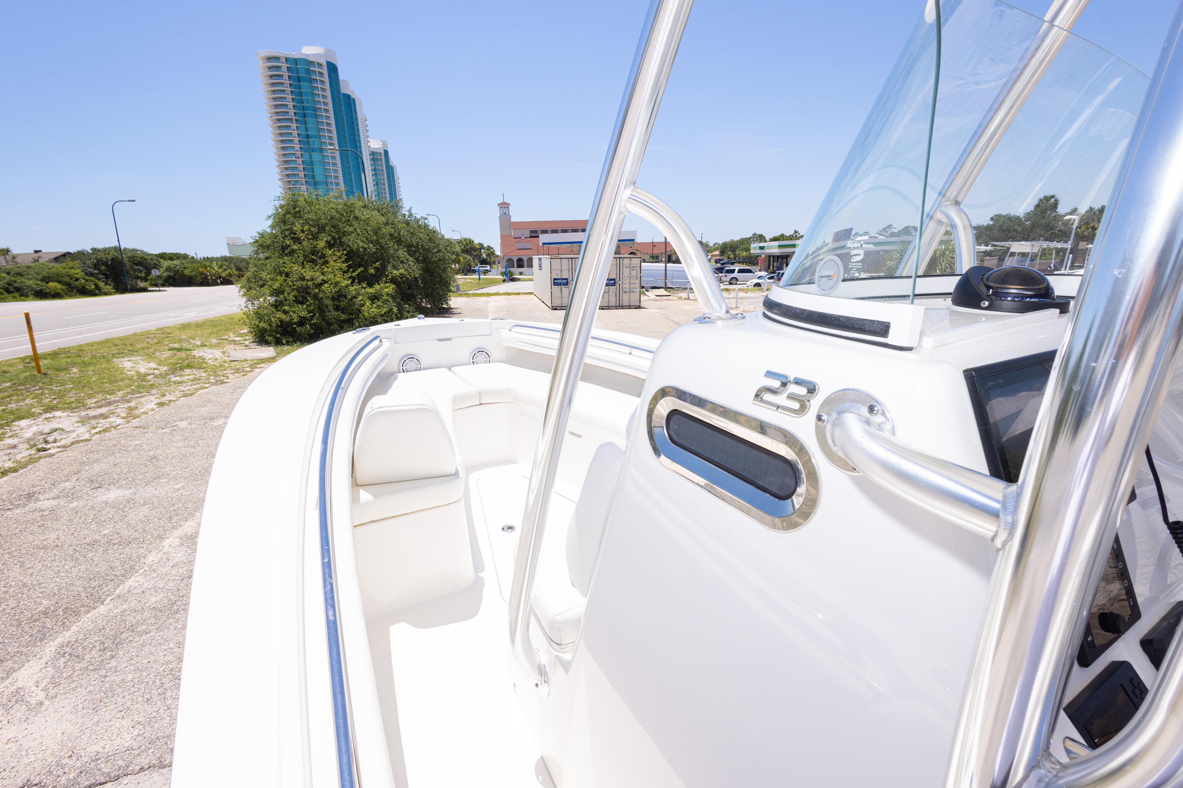 2019 Regulator 23 Center Console boat with urban backdrop and clear sky.