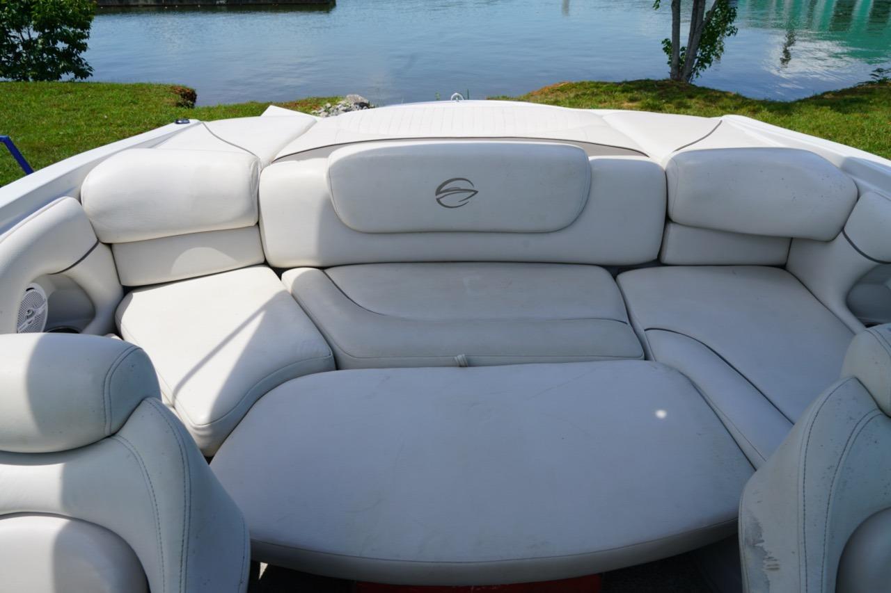 2004 Crownline 216 LS boat interior with white cushioned seating by the water.