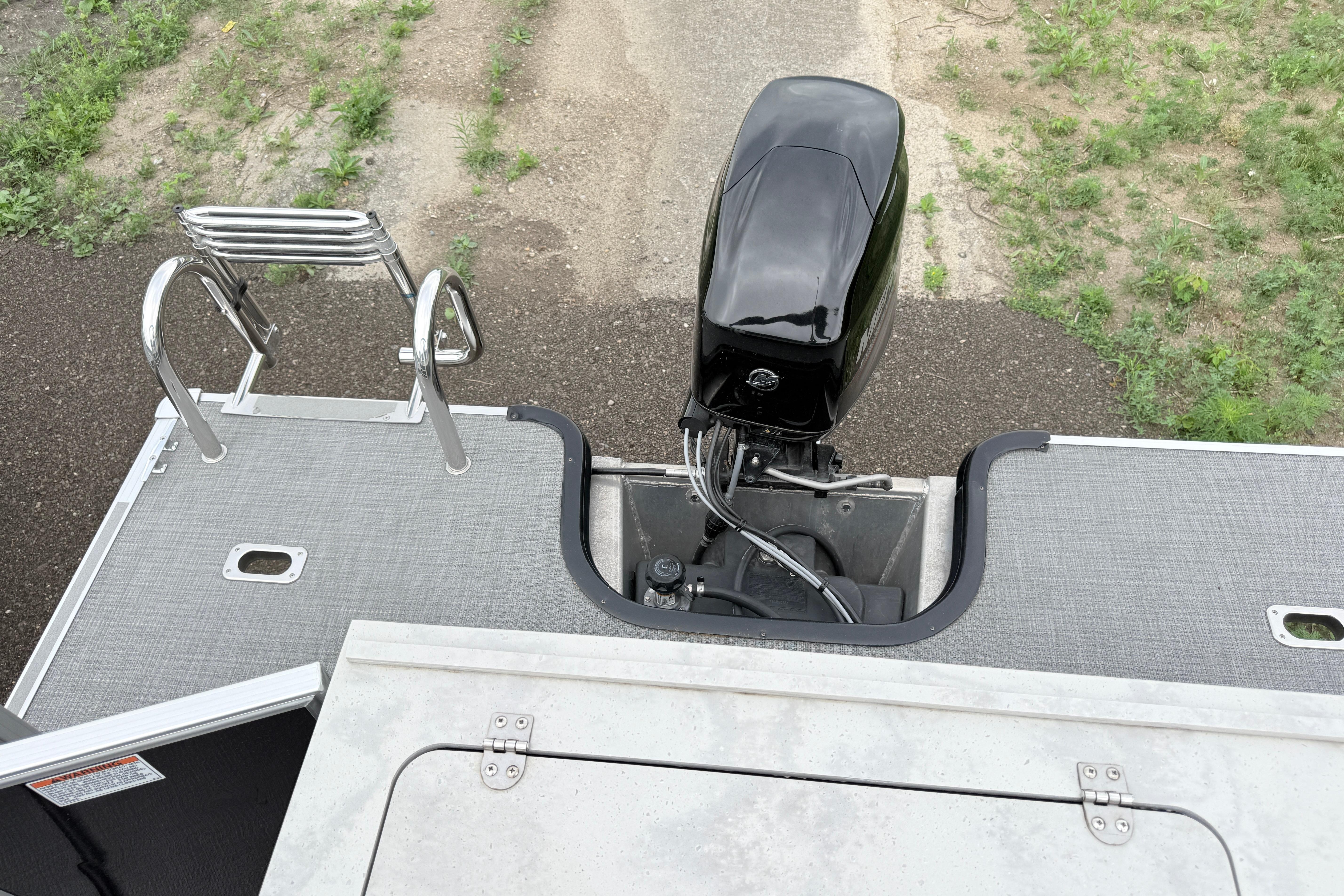2019 Sylvan 8522 Mirage Signature F-n-C boat with outboard motor and swim ladder.