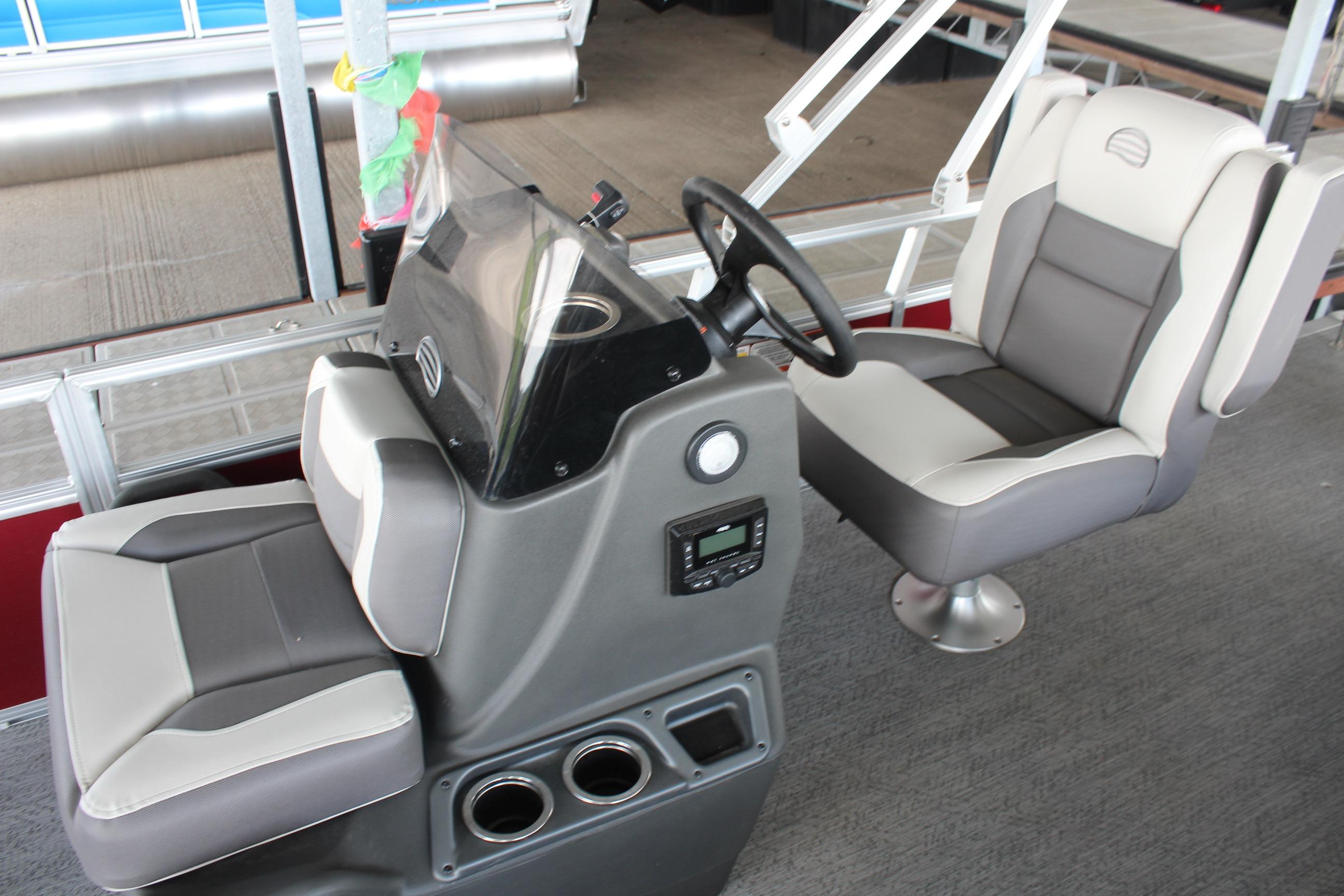 2026 Sun Tracker Bass Buggy 18 DLX interior with steering console and cushioned seats.