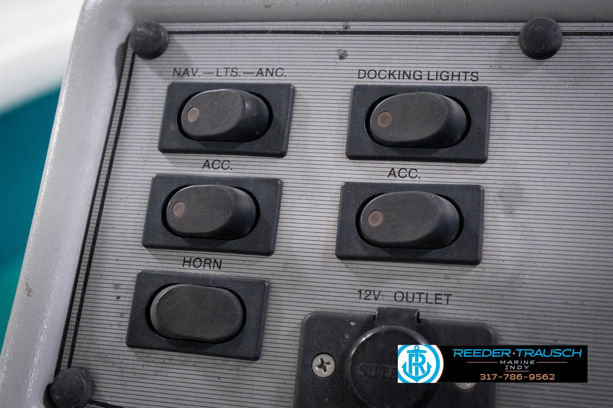 Control panel of a 1992 Godfrey Sweetwater boat with labeled switches and outlets.