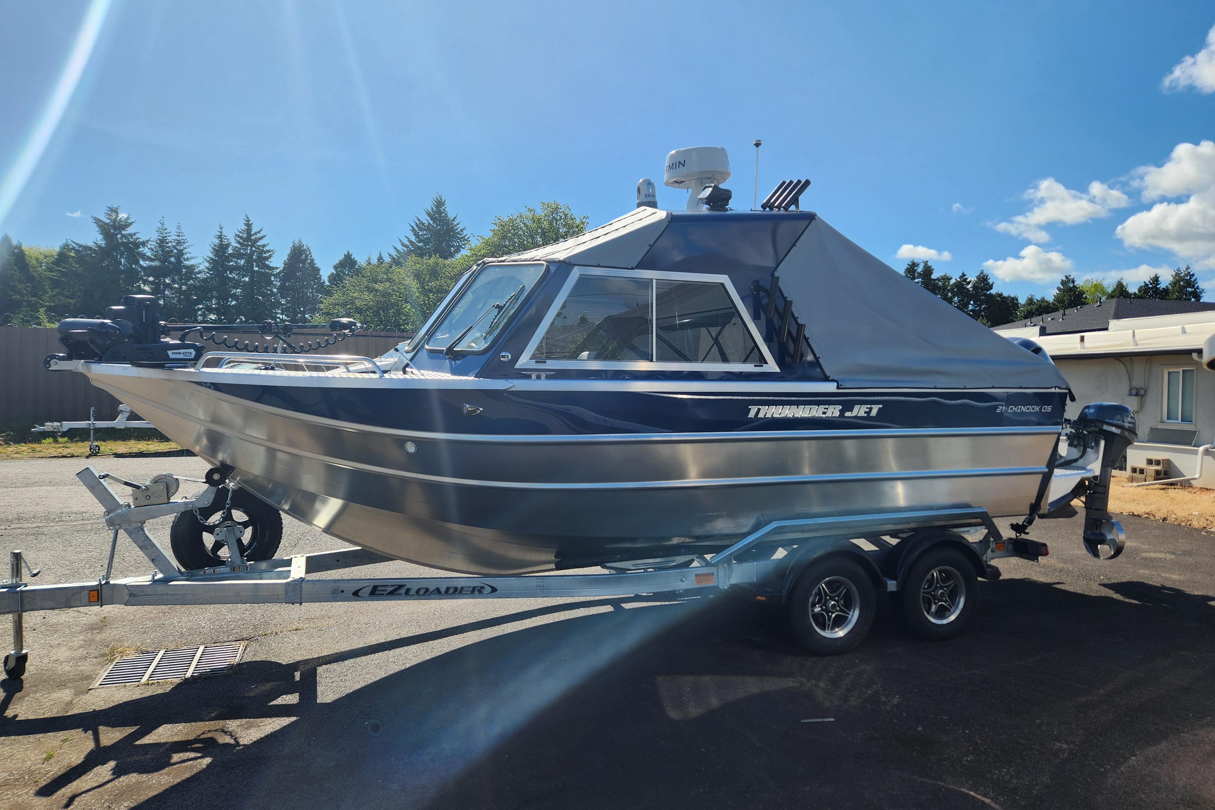 2025 Thunder Jet 21 Chinook OS boat on trailer, parked outdoors under clear sky.