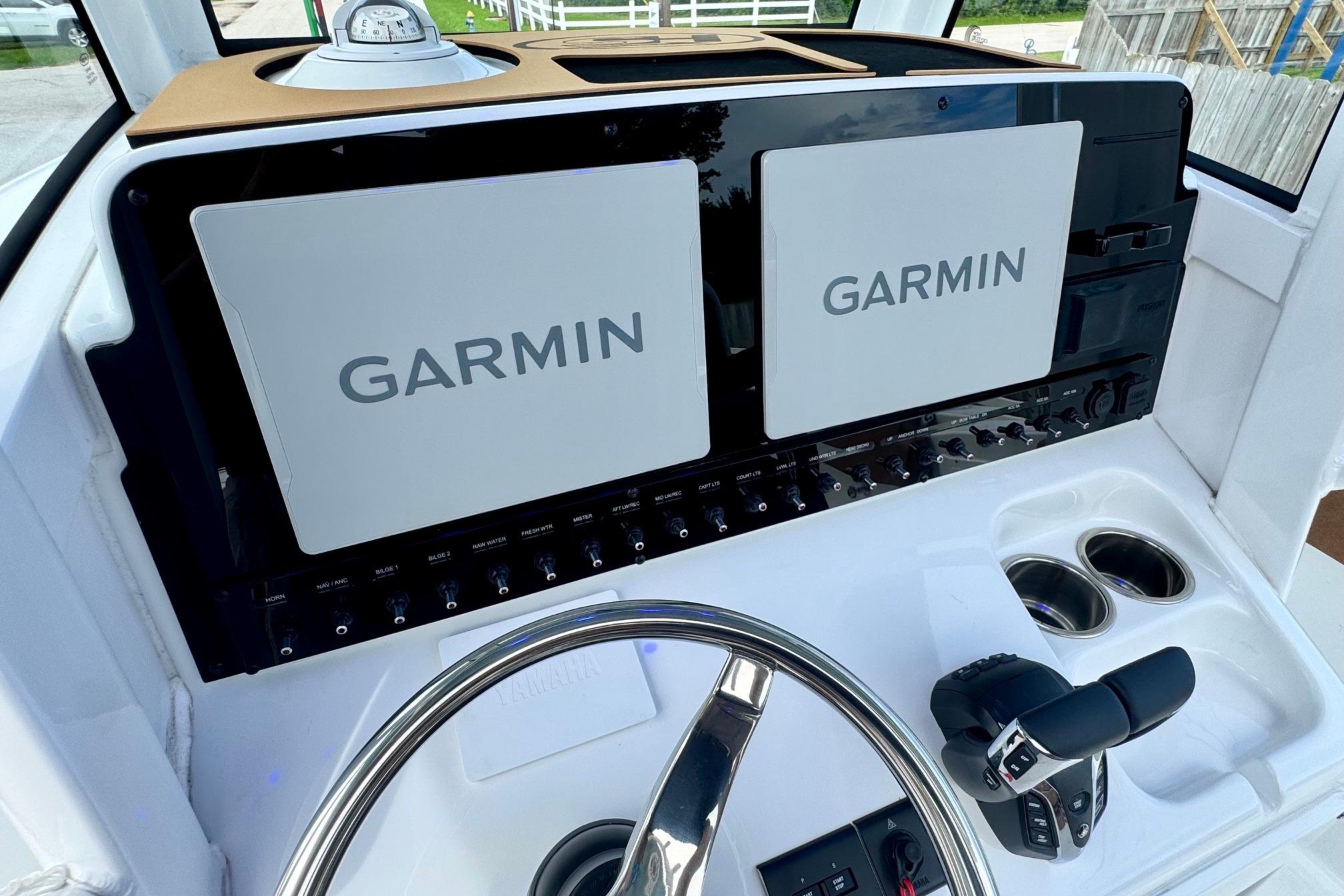 Helm of 2026 Sea Hunt Ultra 275 SE with dual Garmin displays and controls.