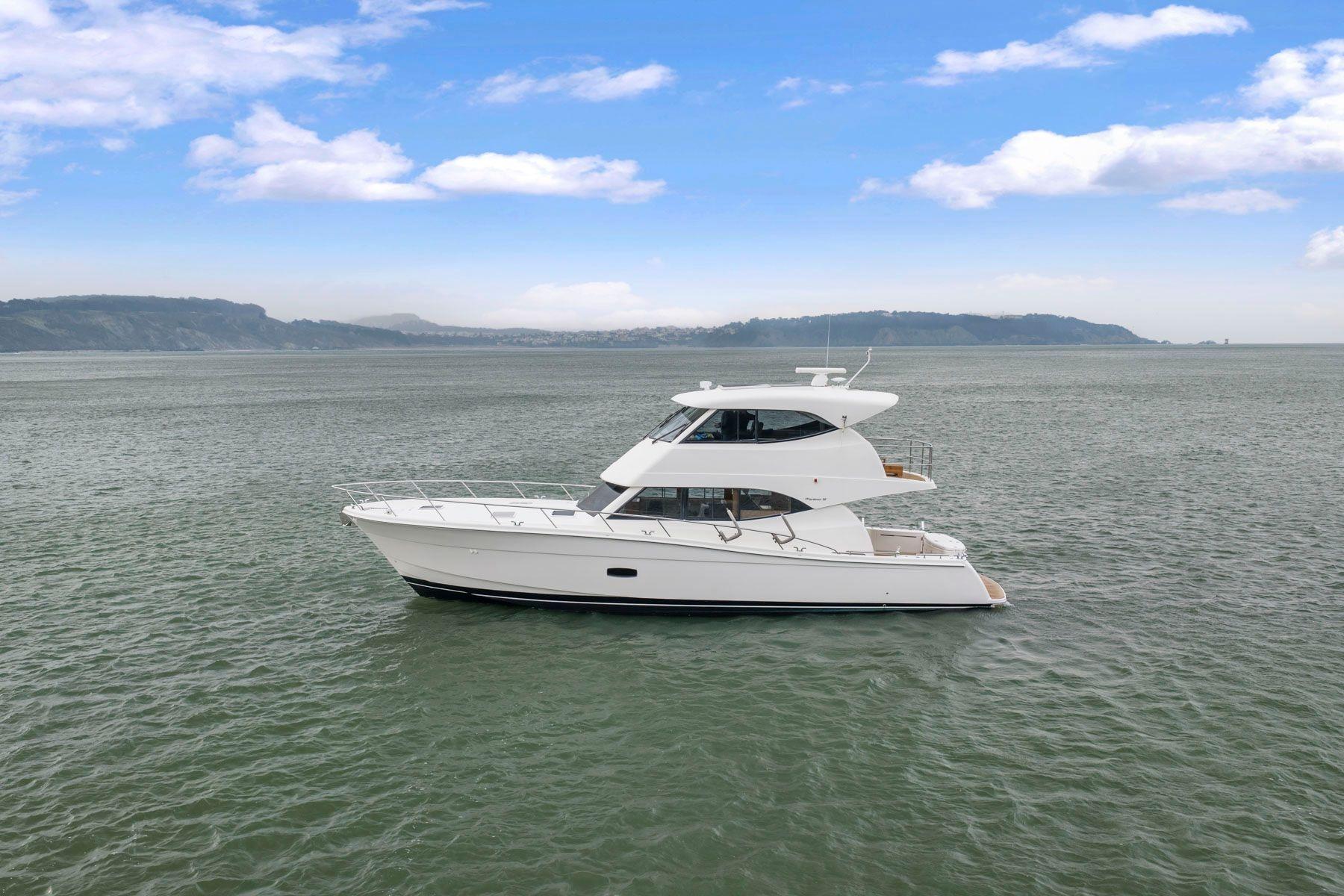 2014 Maritimo M50 yacht cruising on open water under a clear blue sky.