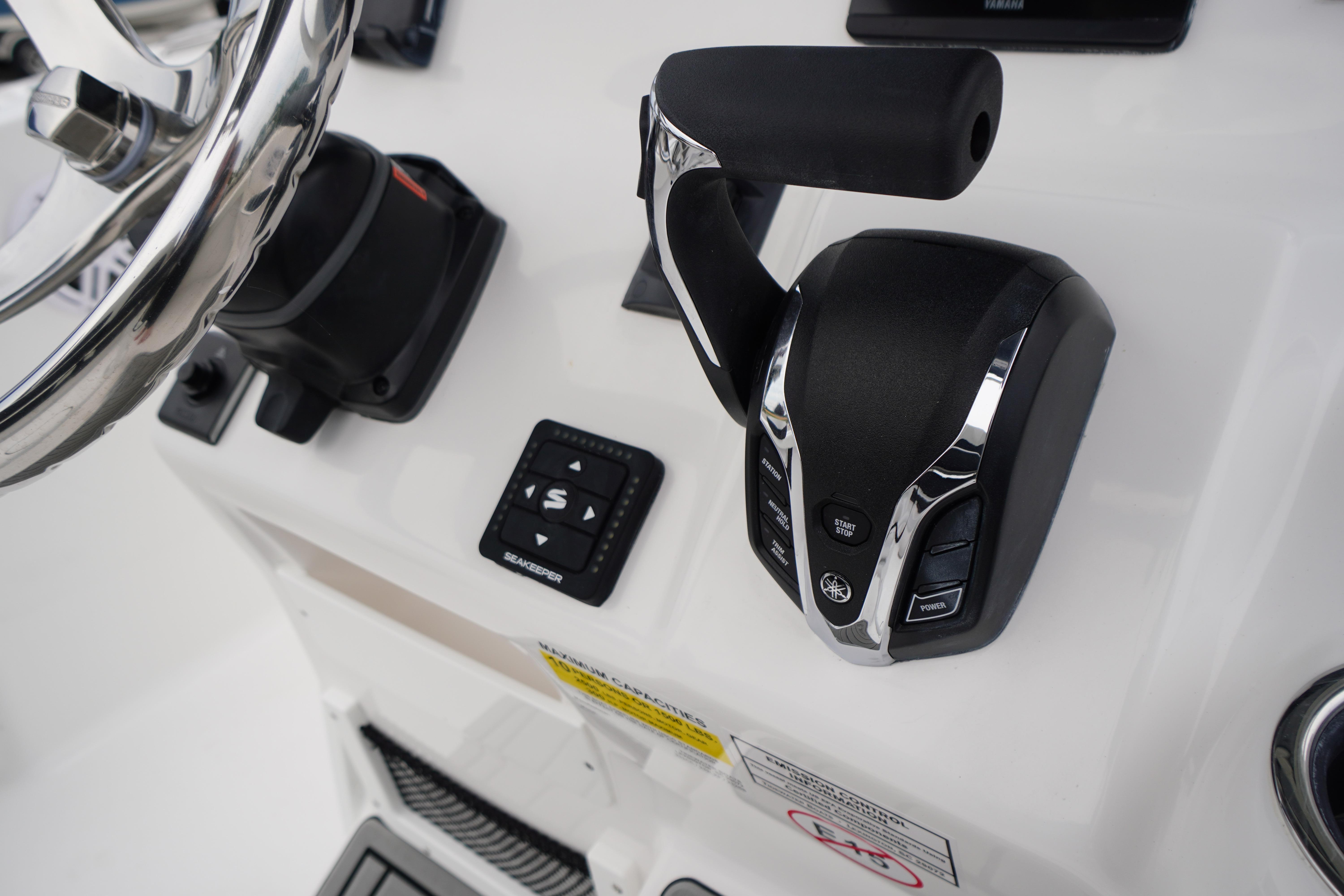 Close-up of 2026 Tidewater 232 SS boat controls and steering wheel.