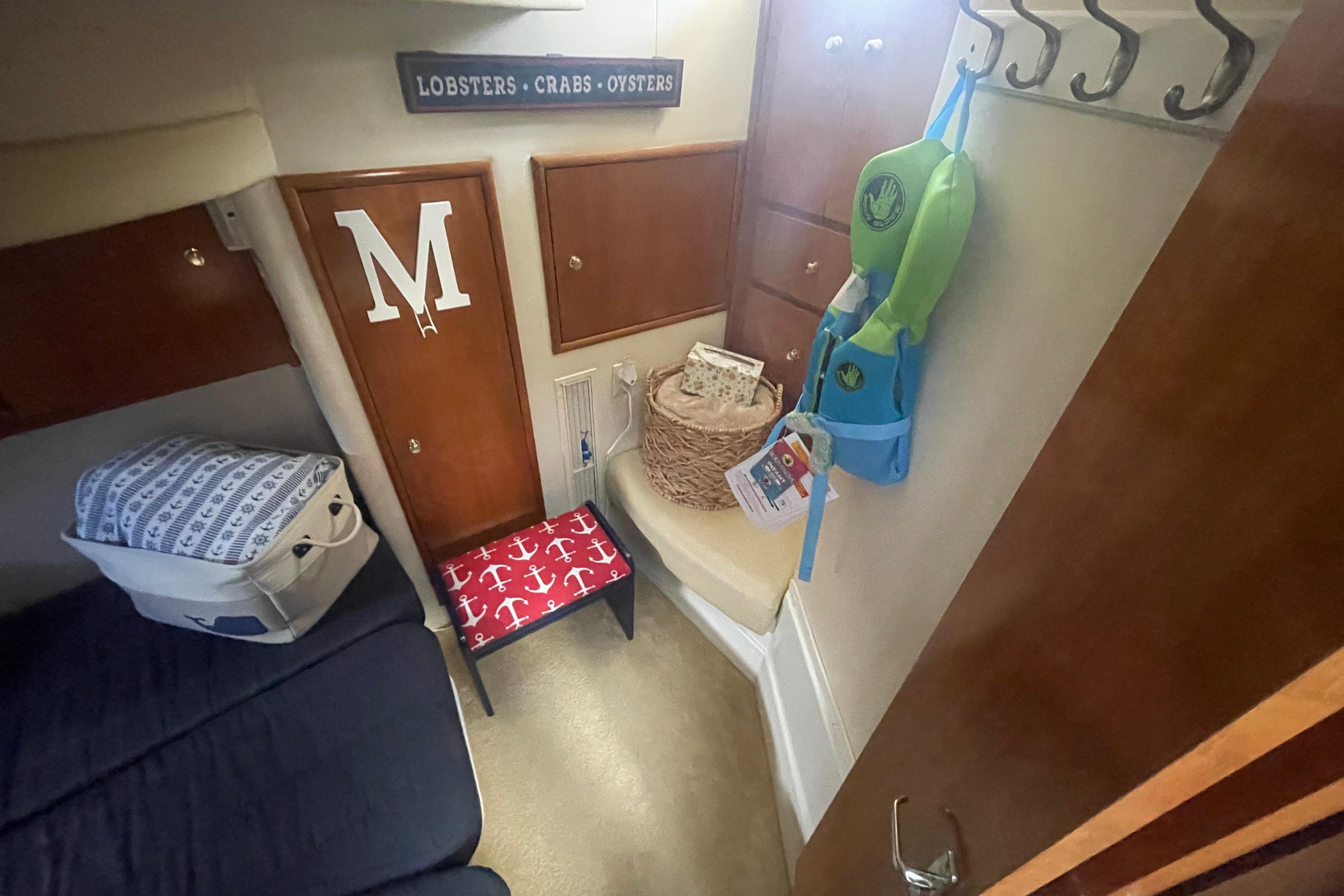 Interior of 2002 Carver 410 Sport Sedan with nautical decor and storage.