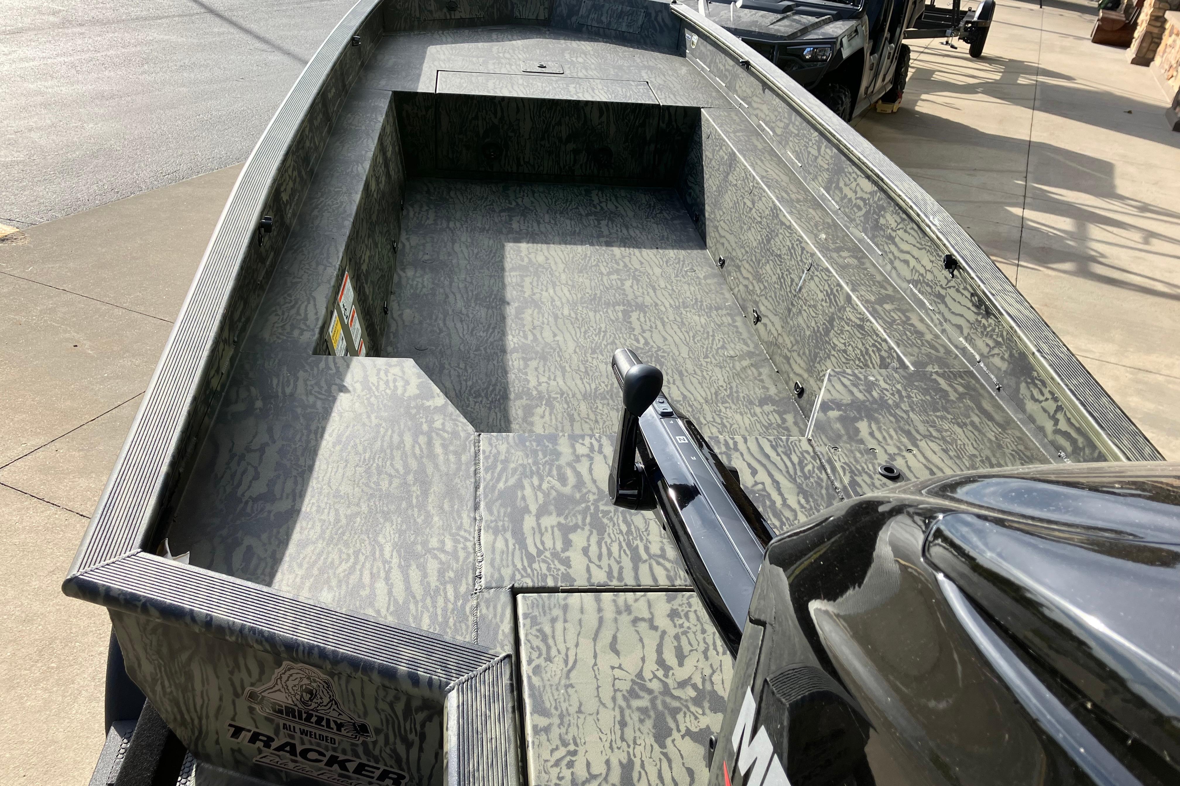 2026 Tracker Grizzly 1650 T Prairie Wings Edition boat with camouflage interior design.