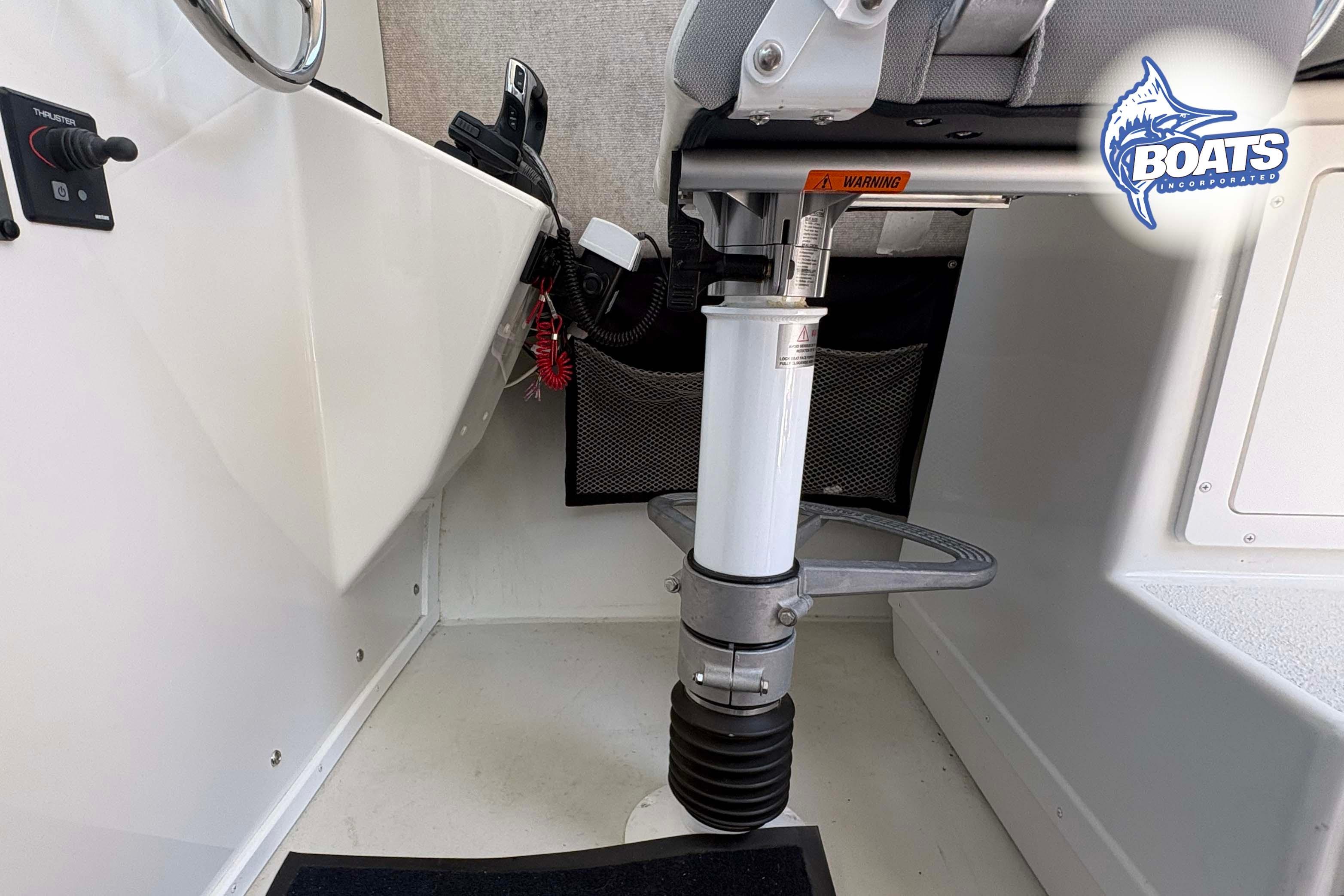 Interior of 2021 Parker 2520 XLD Sport Cabin boat, featuring steering and seating area.