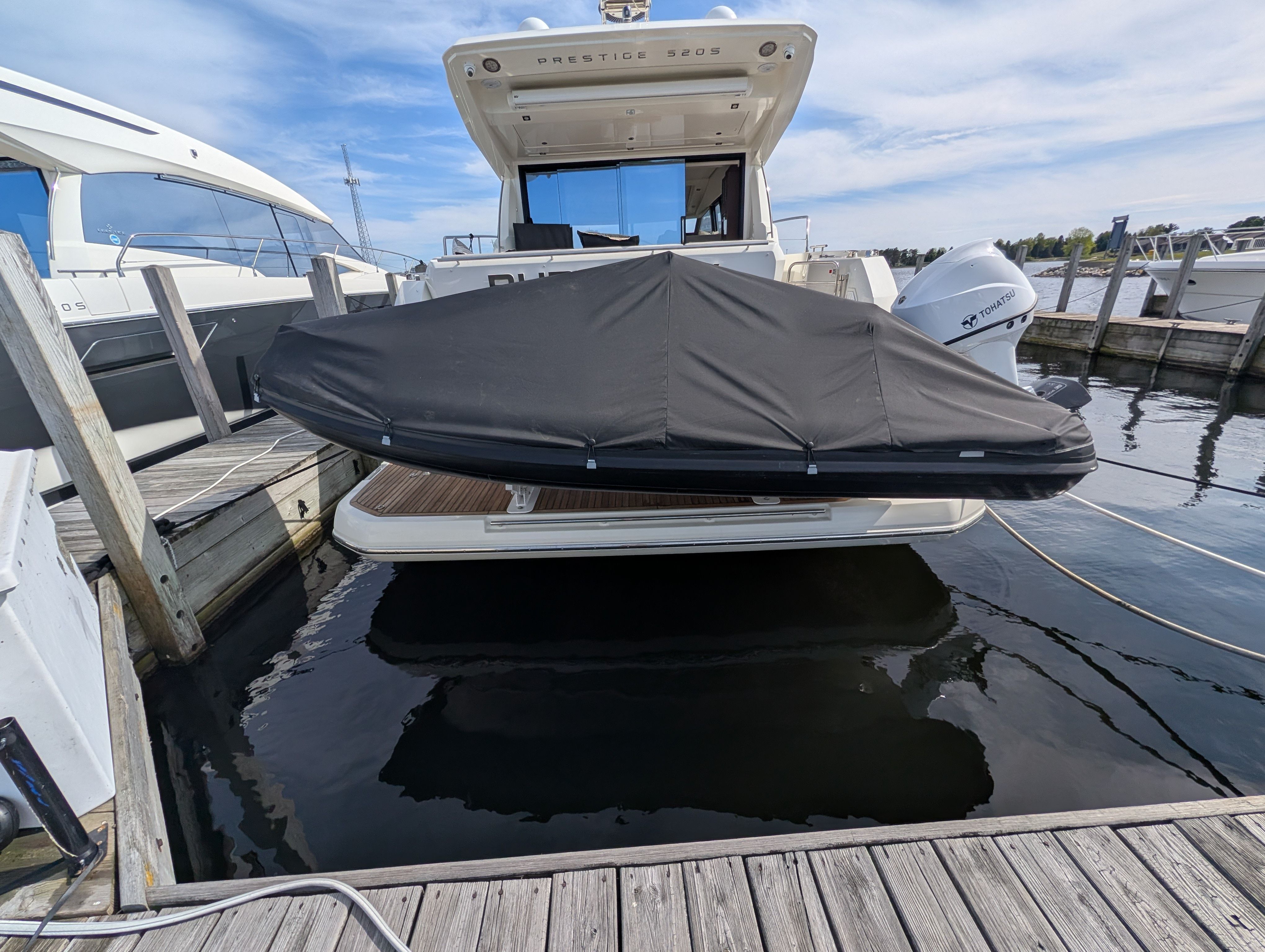 2024 Highfield Sport 390 boat with cover in marina.