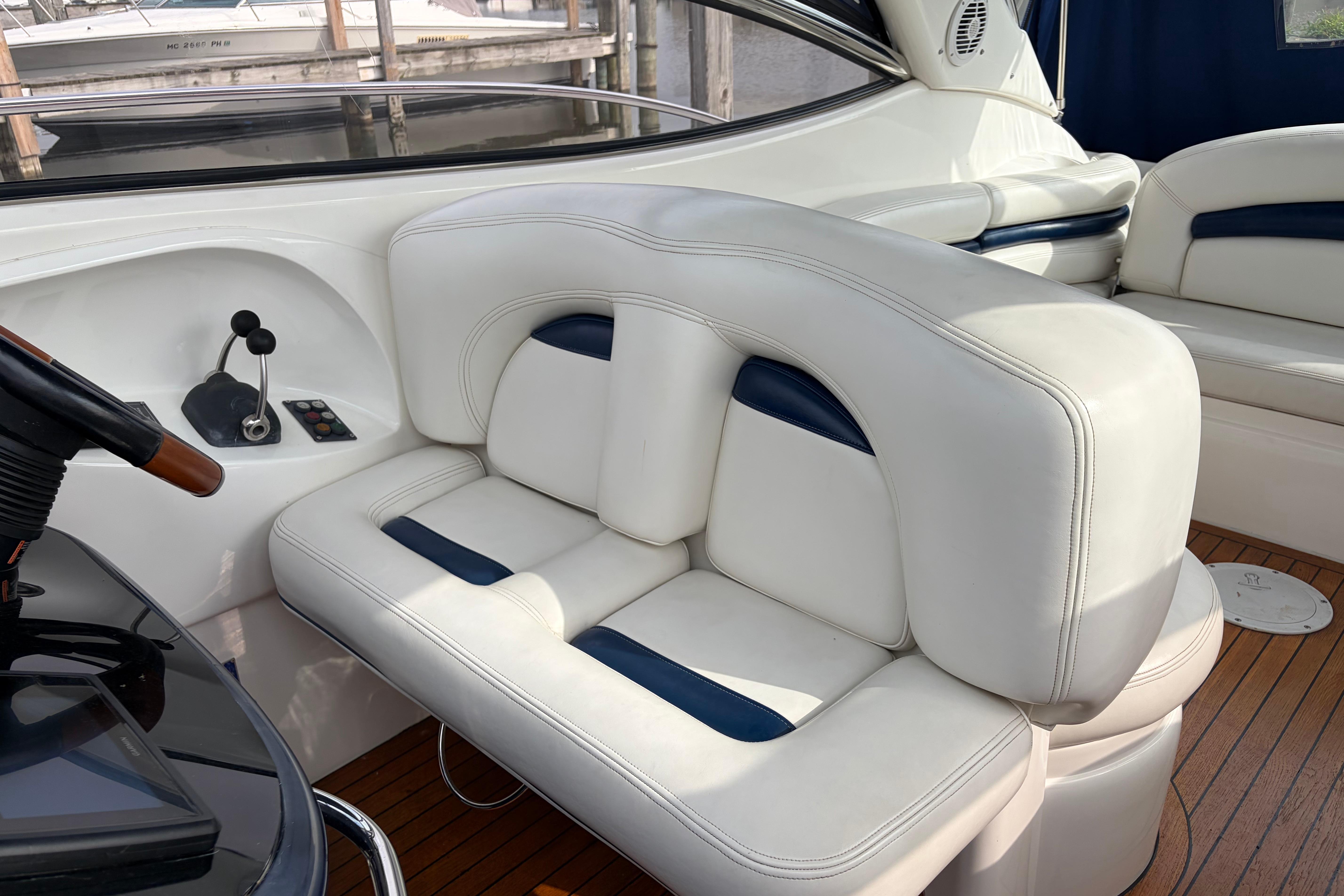Luxurious seating on a 2000 Sunseeker Superhawk 34 yacht with elegant white upholstery.
