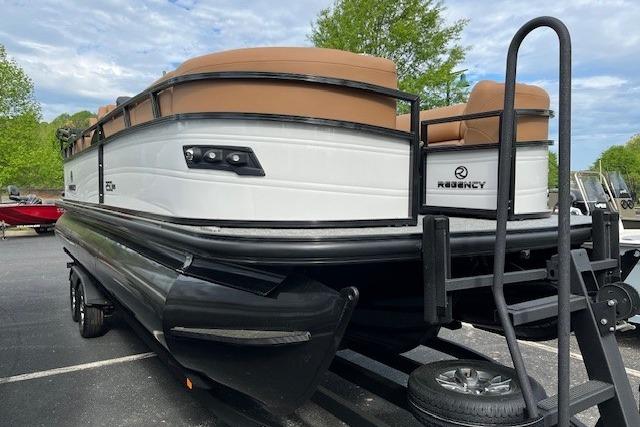 2026 Regency 250 DL pontoon boat with sleek design, parked on a trailer.