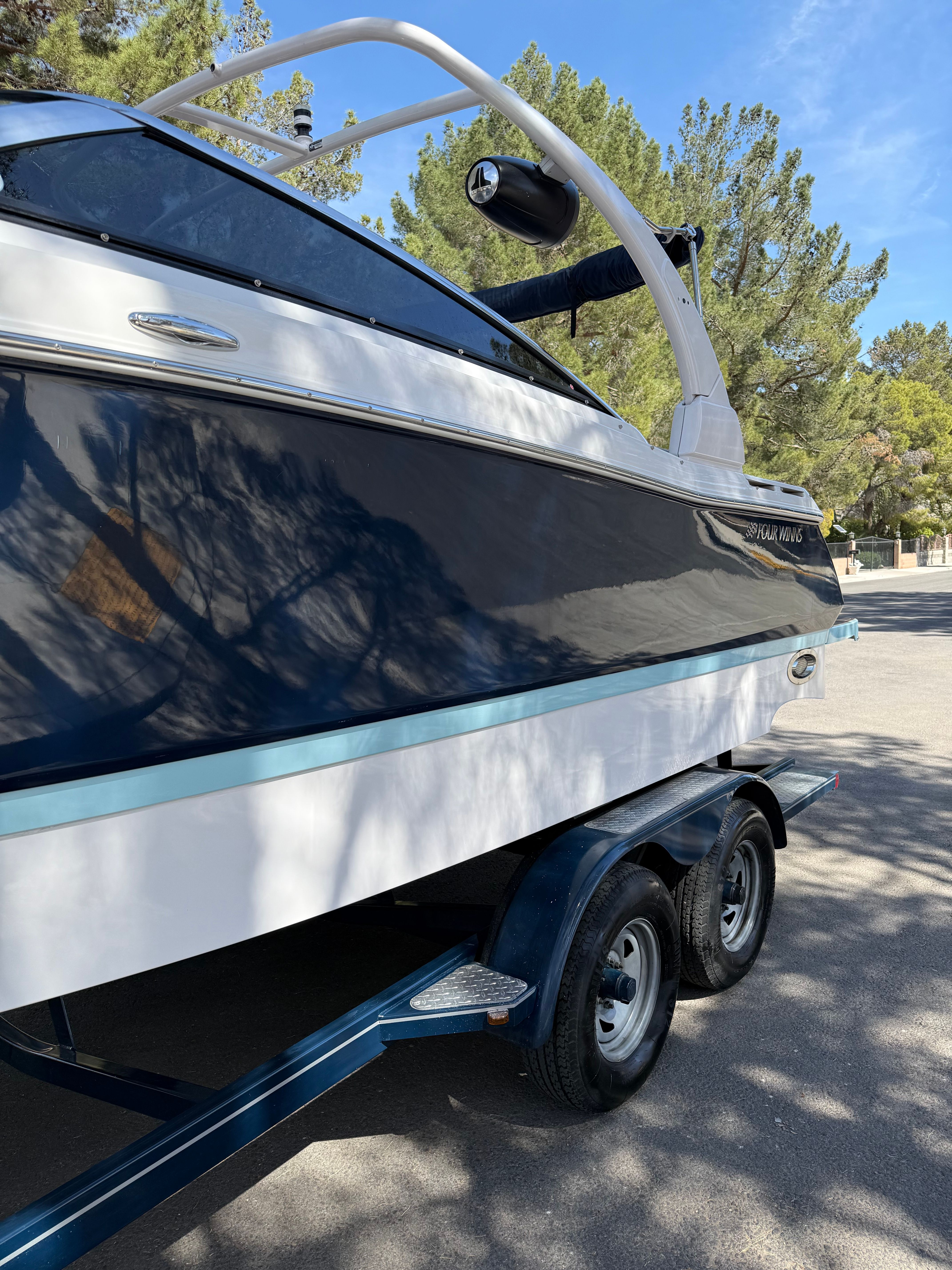 2019 Four Winns H260 boat on trailer outdoors.