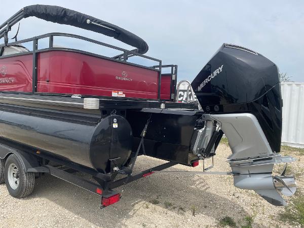 2023 Regency 250DL3 pontoon boat with Mercury outboard motor on a trailer.