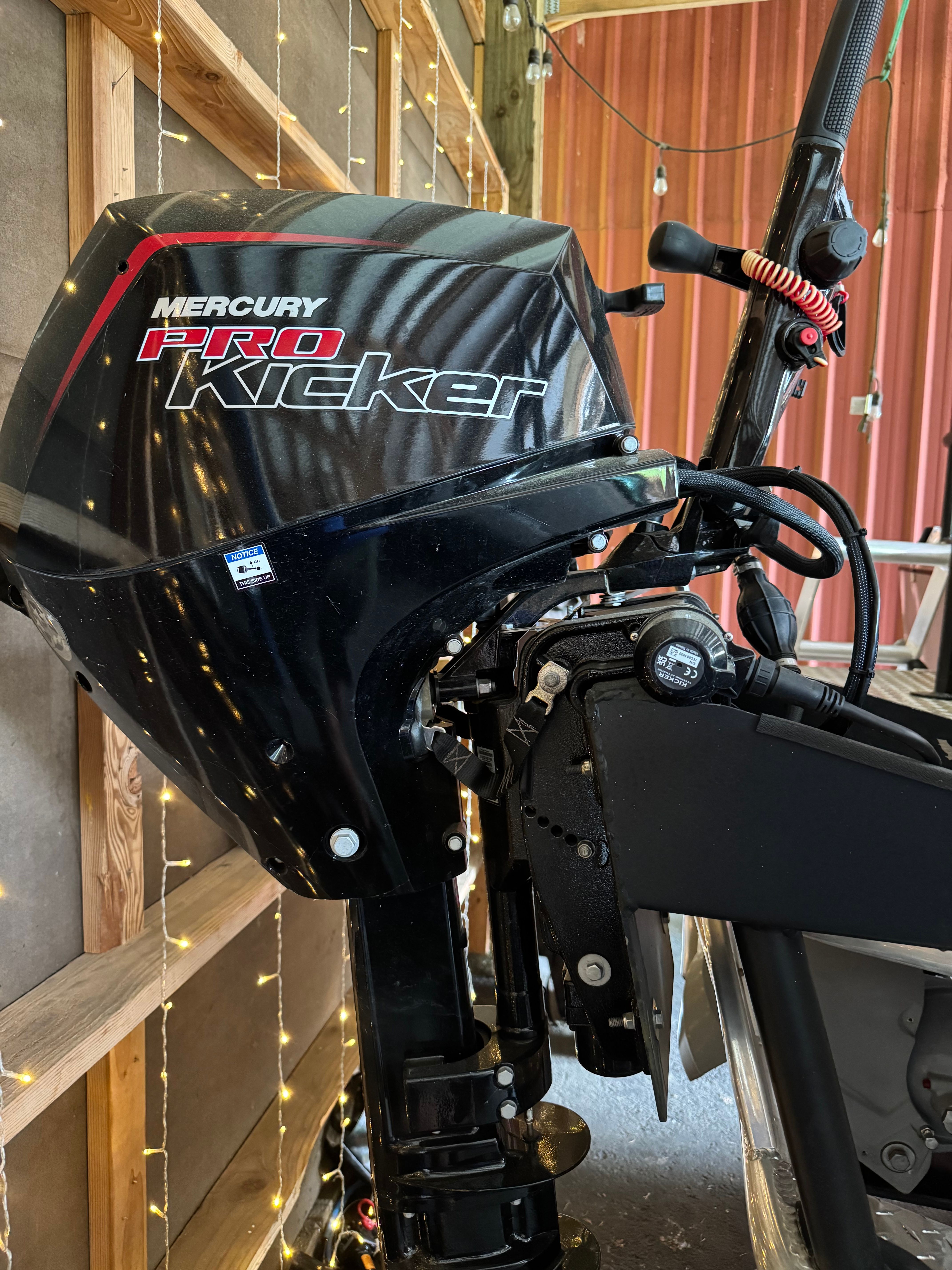 Mercury Pro Kicker outboard motor in a workshop.