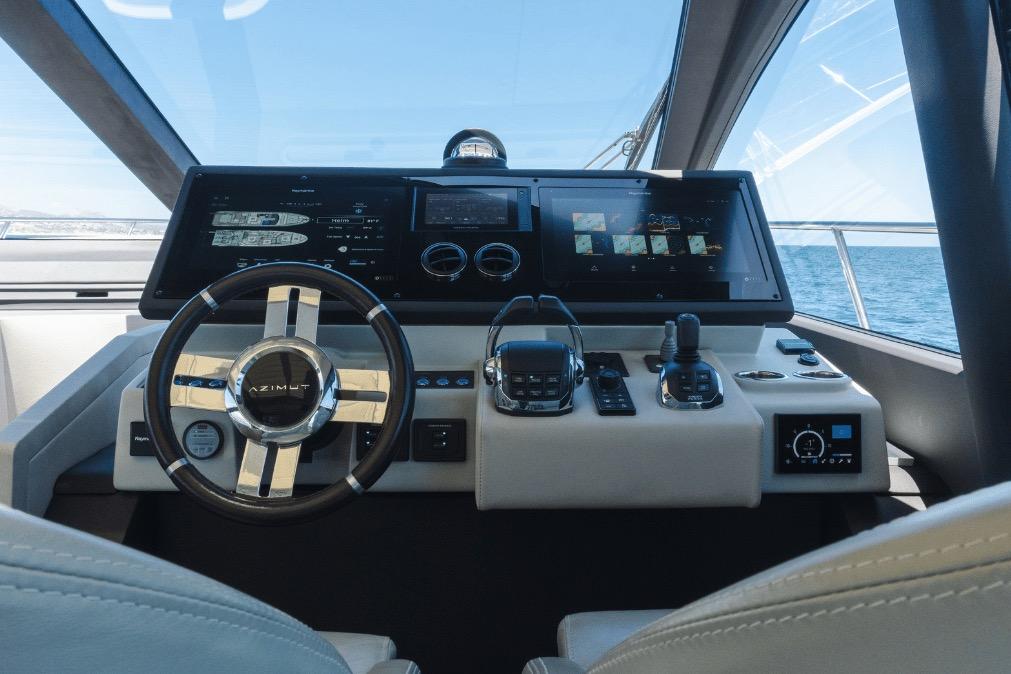 Cockpit of 2020 Azimut 60 yacht with modern navigation controls and steering wheel.