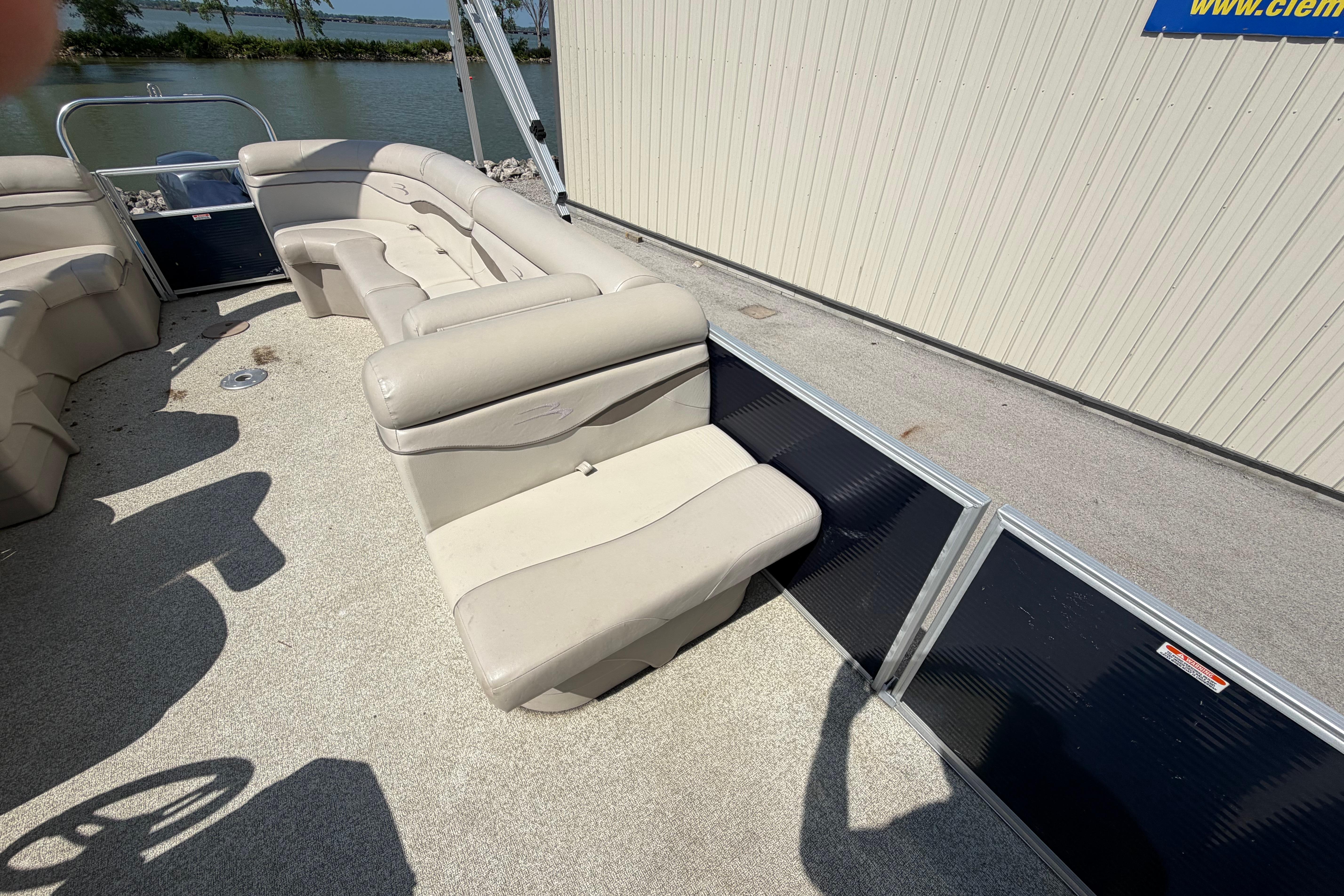 2017 Bennington 25 SSXAPG pontoon boat interior with beige seating and waterfront view.