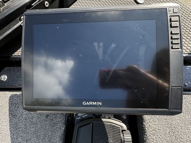 Garmin display on 2024 Phoenix Bass Boats 20 XE, showing reflection of sky and hand.