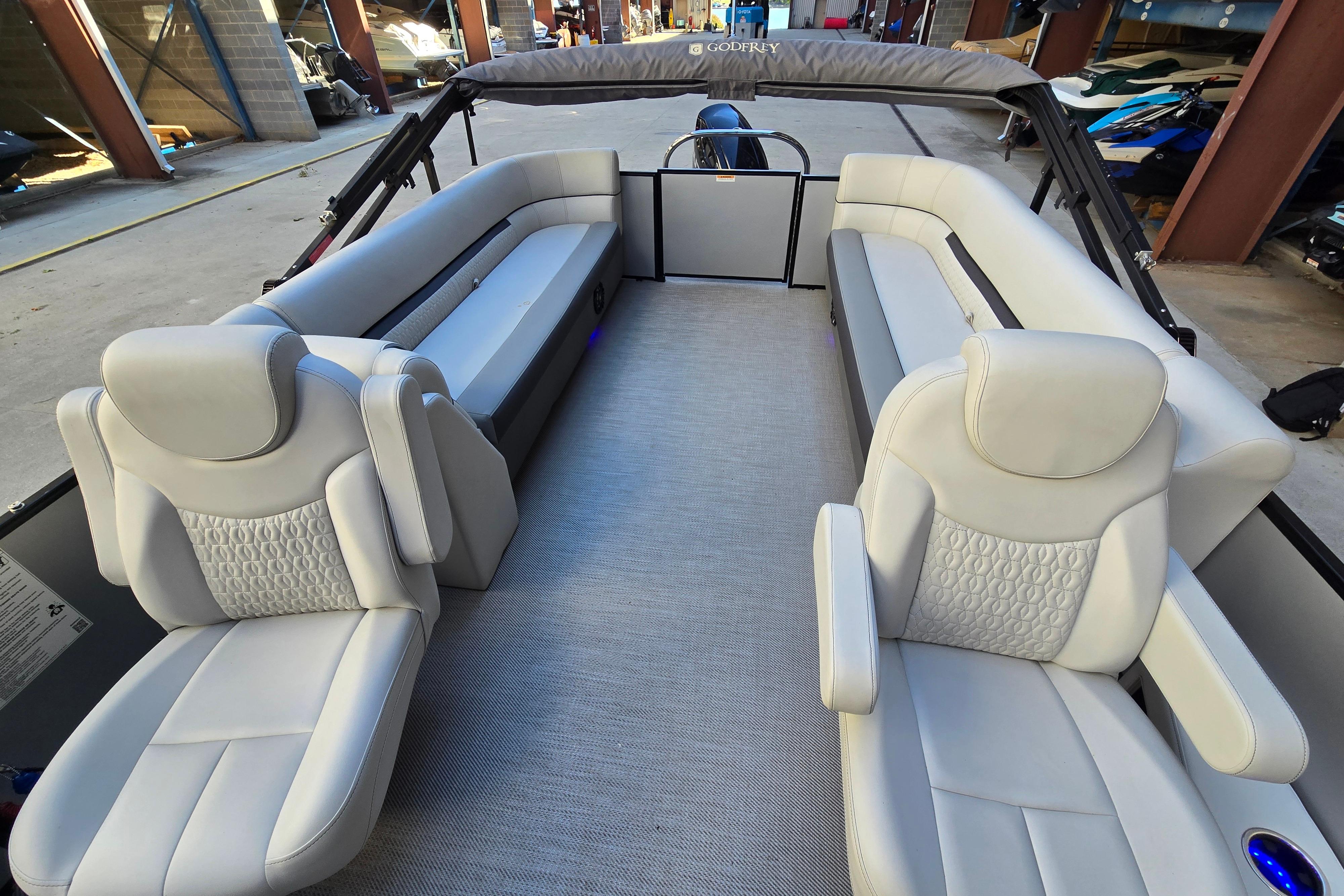 Luxurious interior of 2024 Godfrey Sweetwater 2486 SB pontoon boat with plush seating.