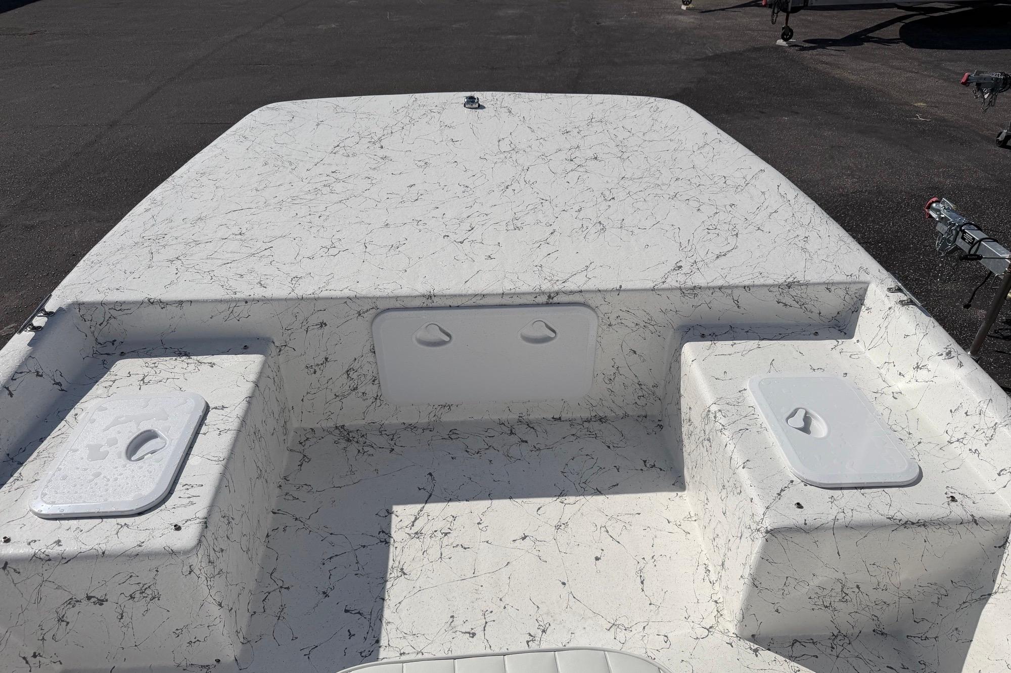 2027 Coastal Skiff 184 boat deck with storage compartments, featuring a marbled white finish.