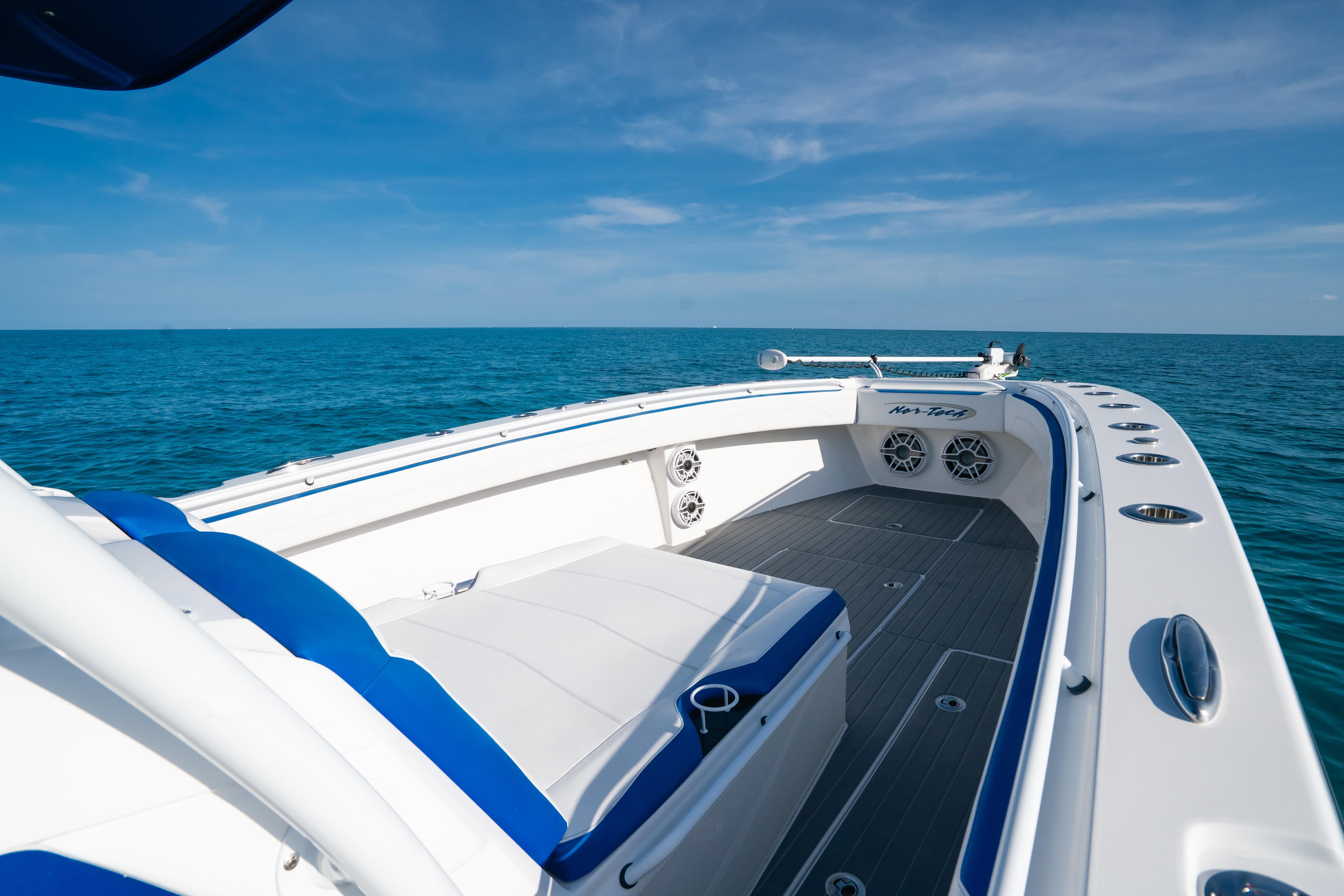 2022 Nor-Tech 392 Super Fish boat on open sea, featuring sleek design and spacious deck.