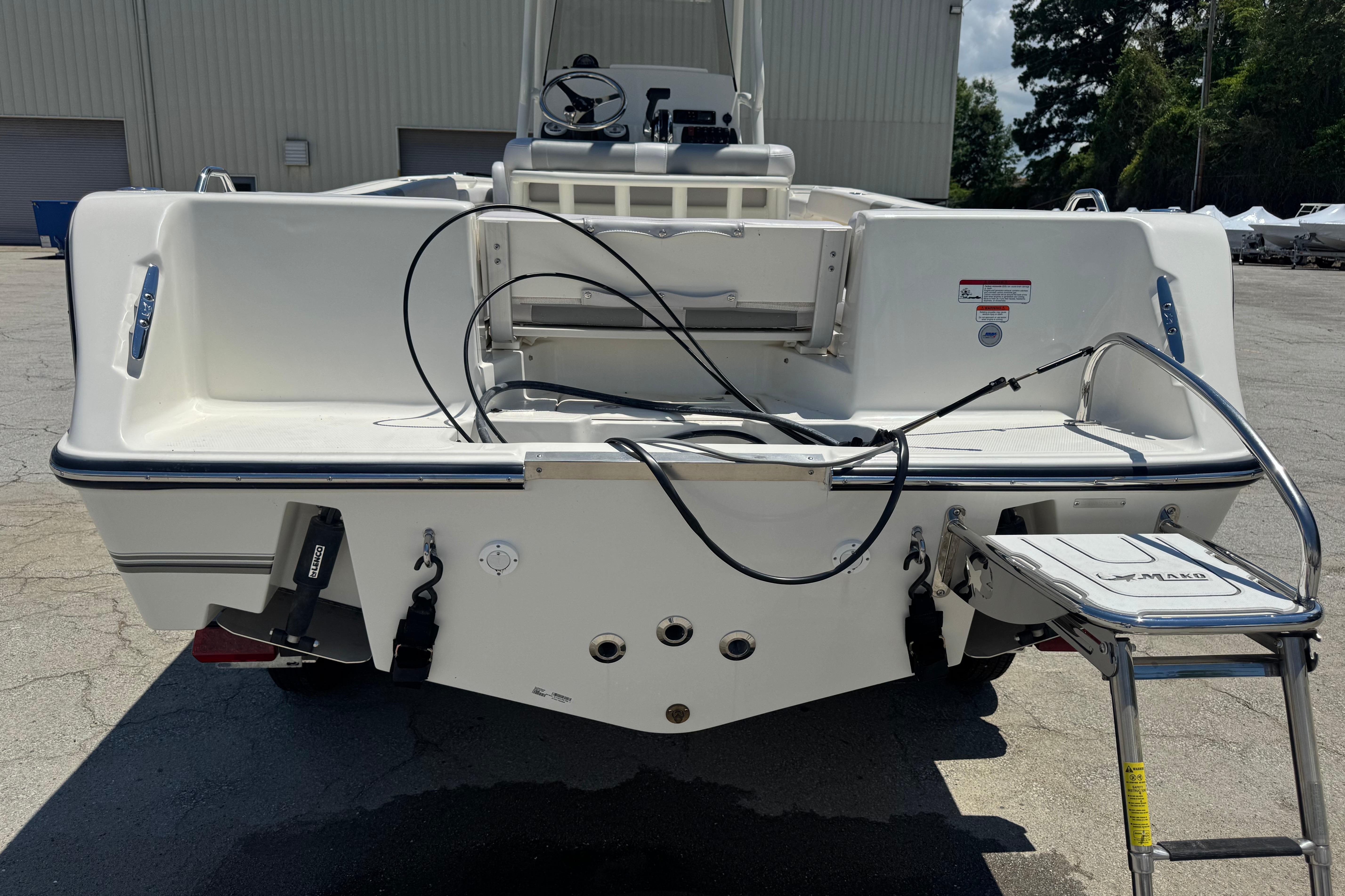 2026 Mako 214 Center Console boat rear view with ladder and cables.