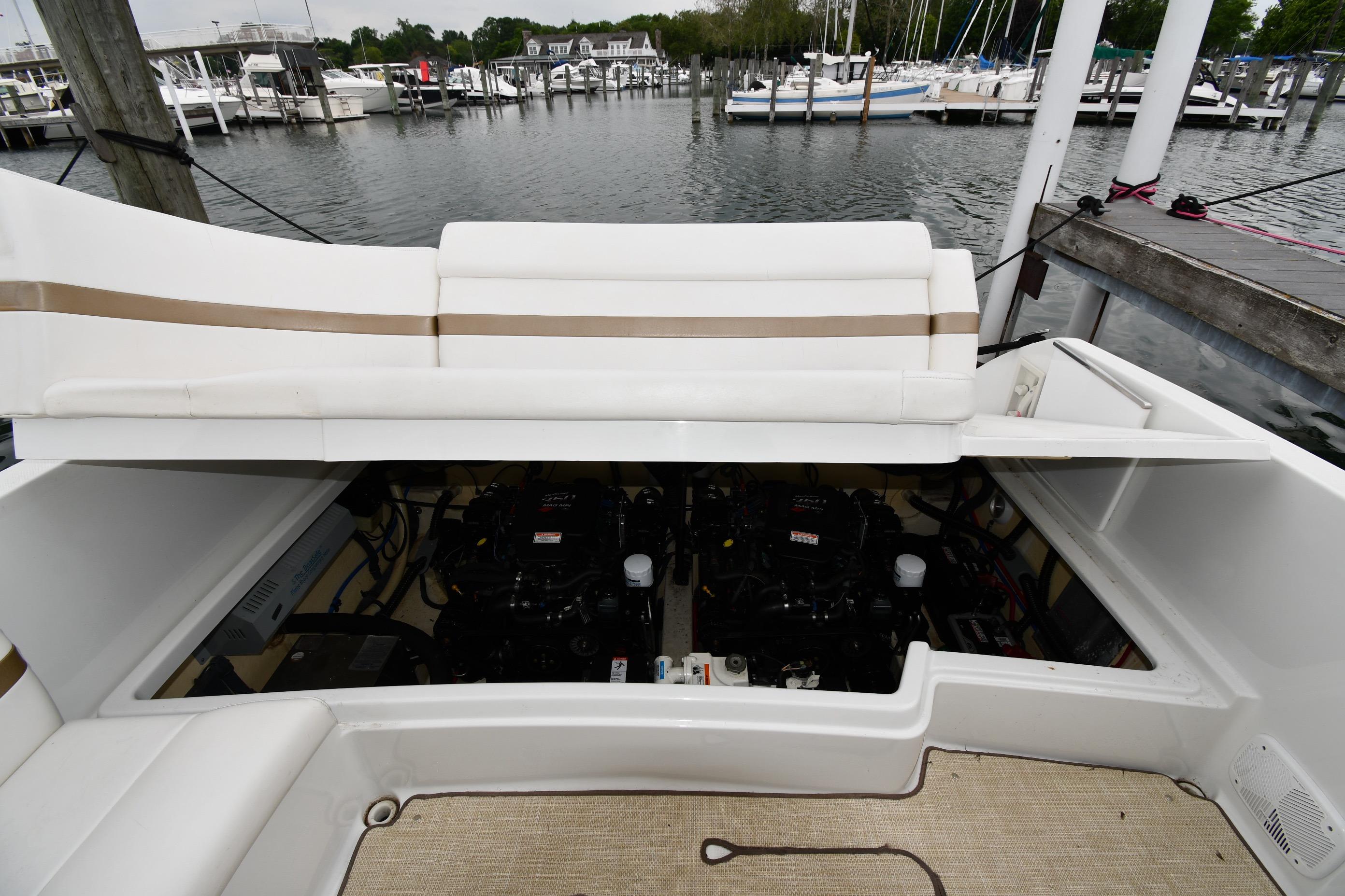 2004 Formula 330 Sun Sport boat engine compartment open at marina.