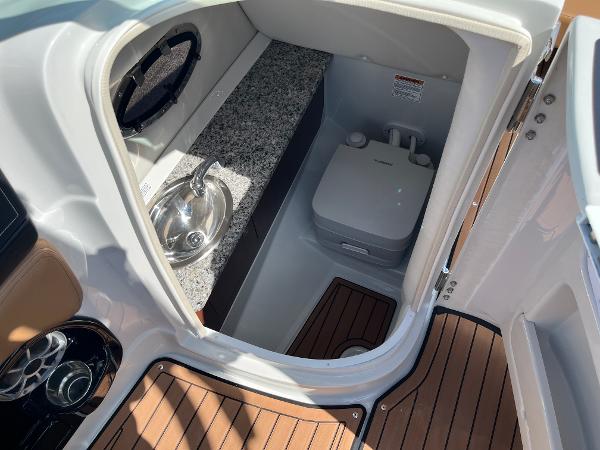2024 Crownline Eclipse E255 boat interior with sink and portable toilet.