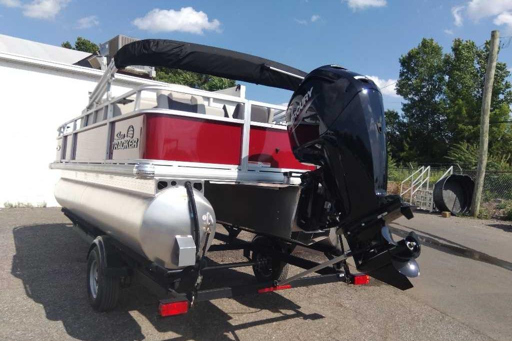 2026 Sun Tracker Bass Buggy 18 DLX pontoon boat with Mercury outboard motor.