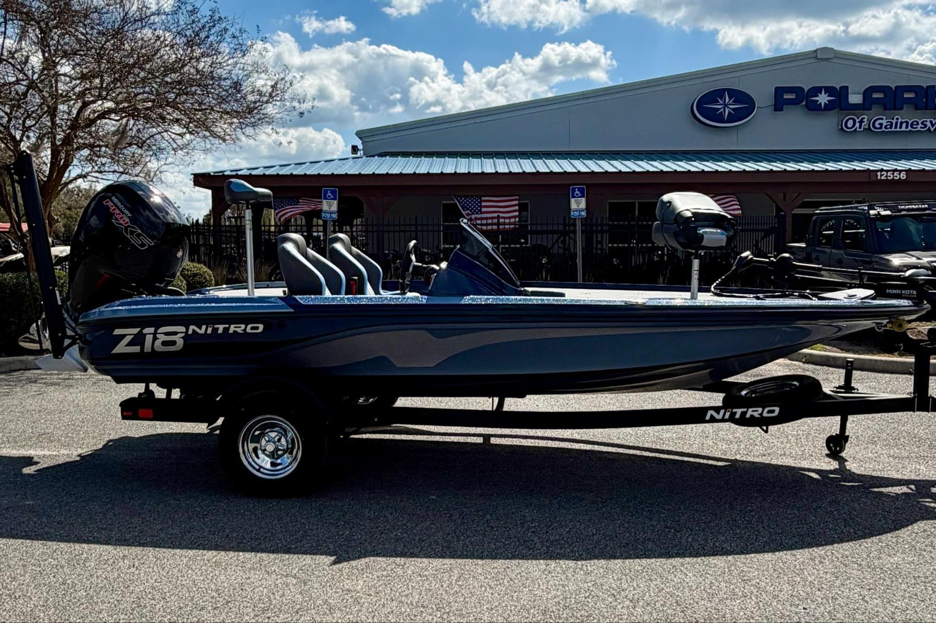 2026 Nitro Z18 boat parked outside dealership under blue sky.