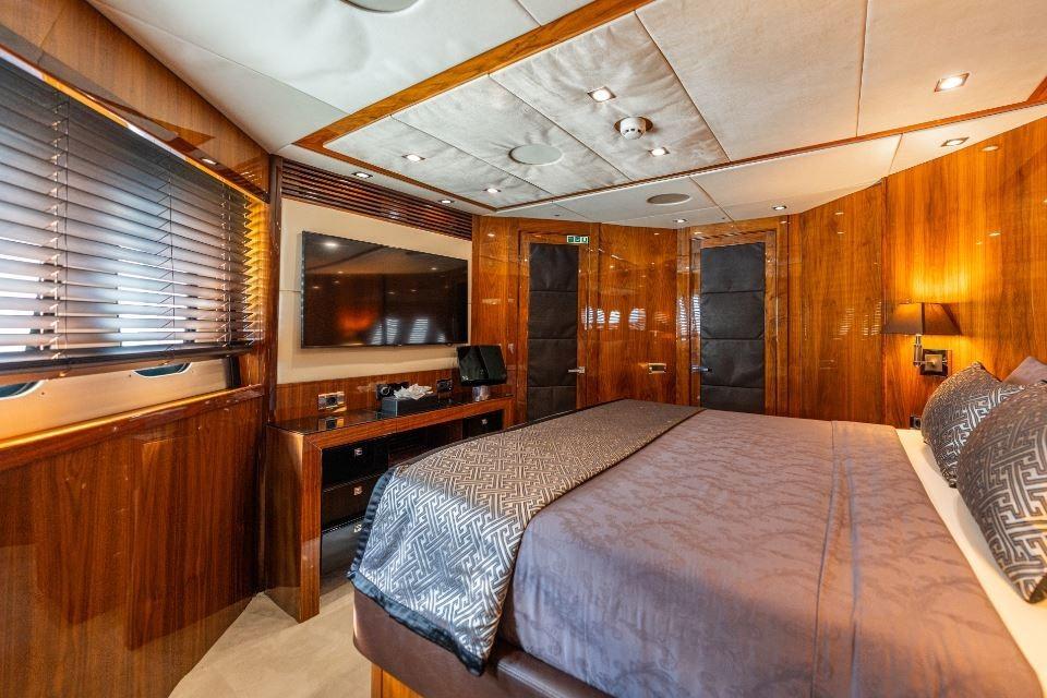 Luxurious bedroom interior of 2009 Sunseeker 34 Metre Yacht with elegant wood paneling.