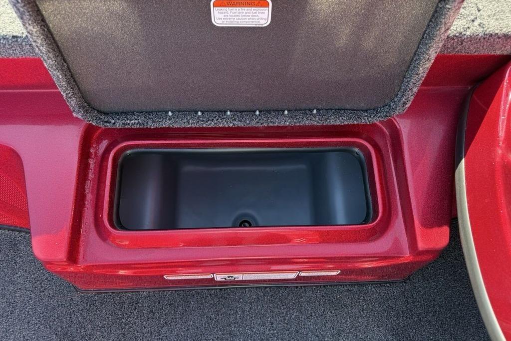 Open storage compartment in a 2026 Nitro Z17 boat, featuring a red interior.