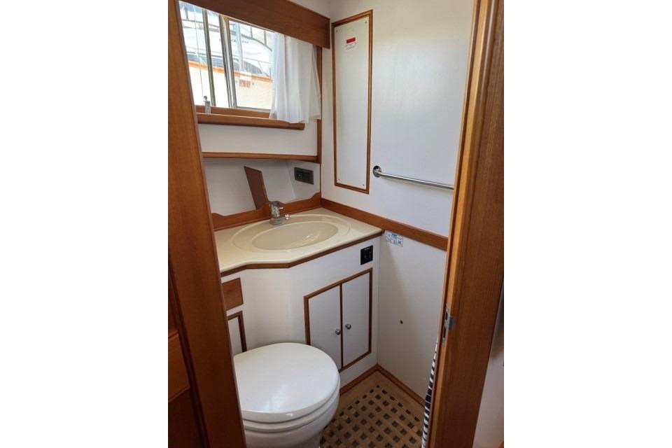 2000 Grand Banks 36 Classic yacht bathroom with sink, toilet, and wooden accents.
