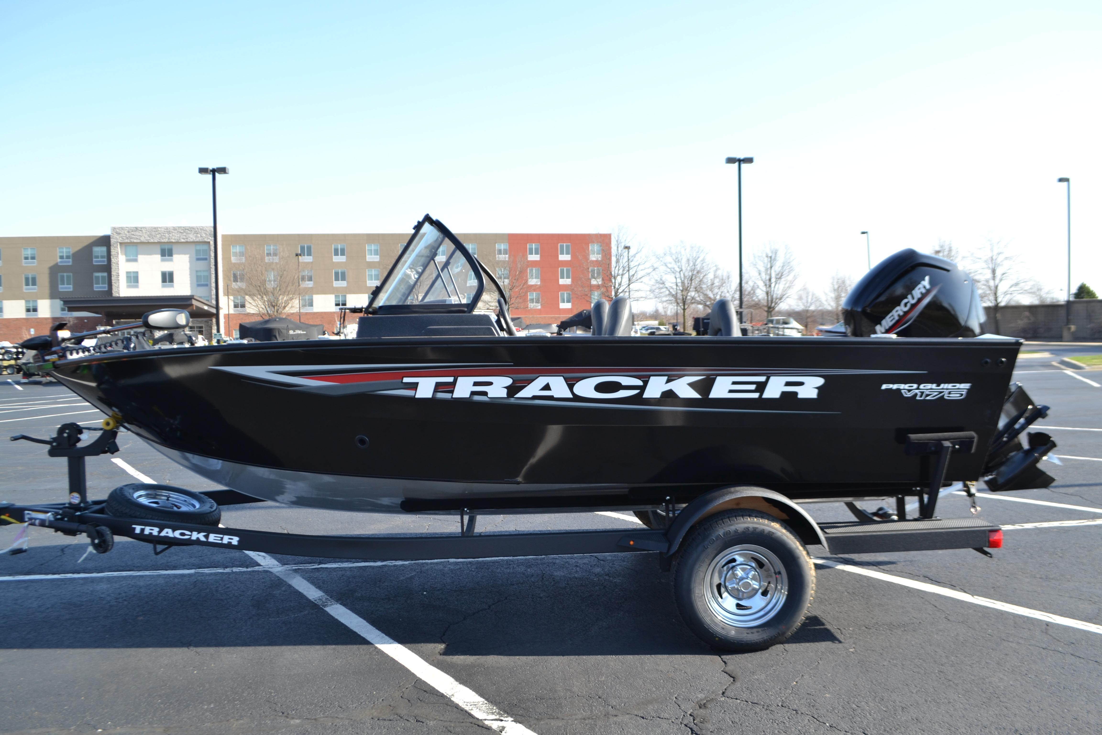 2026 Tracker Pro Guide V-175 WT boat on trailer in parking lot.