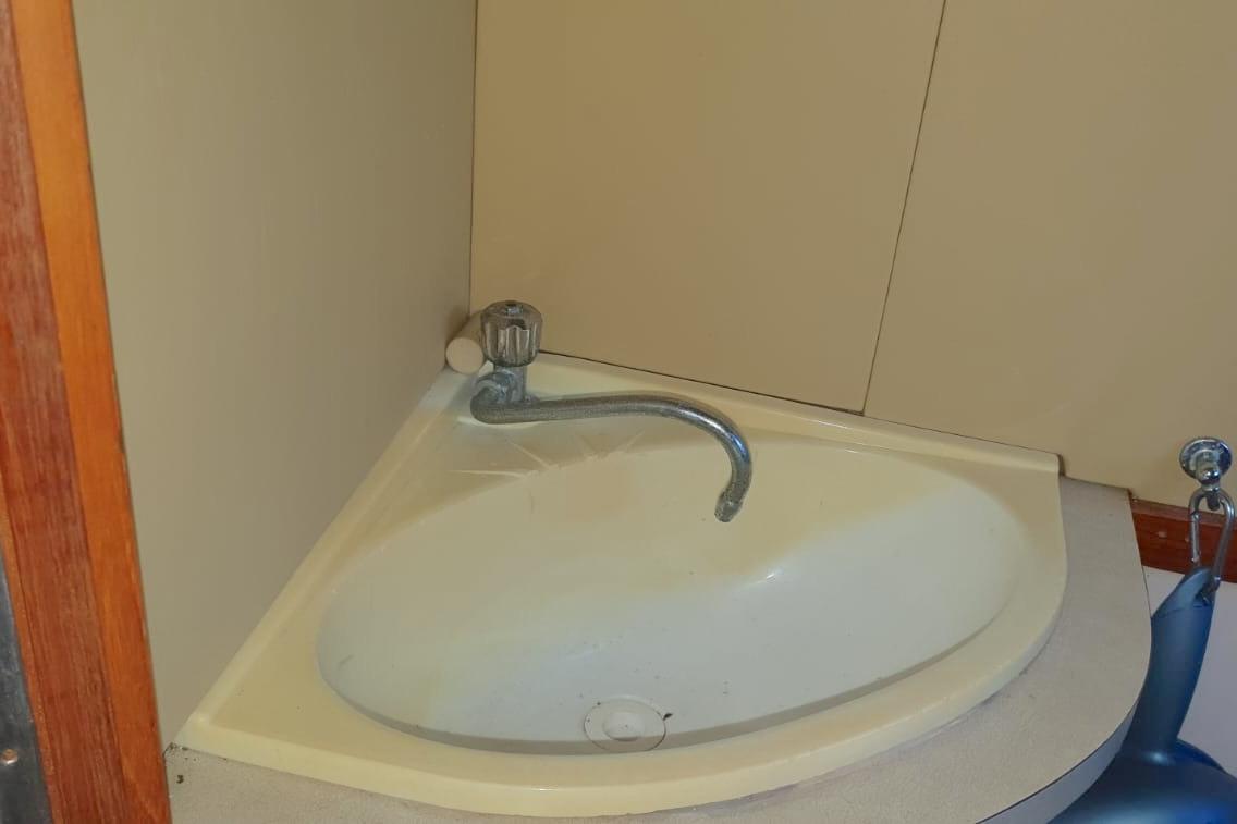 Corner sink with curved faucet in a 1989 Fairey Spearfish MKIII boat.