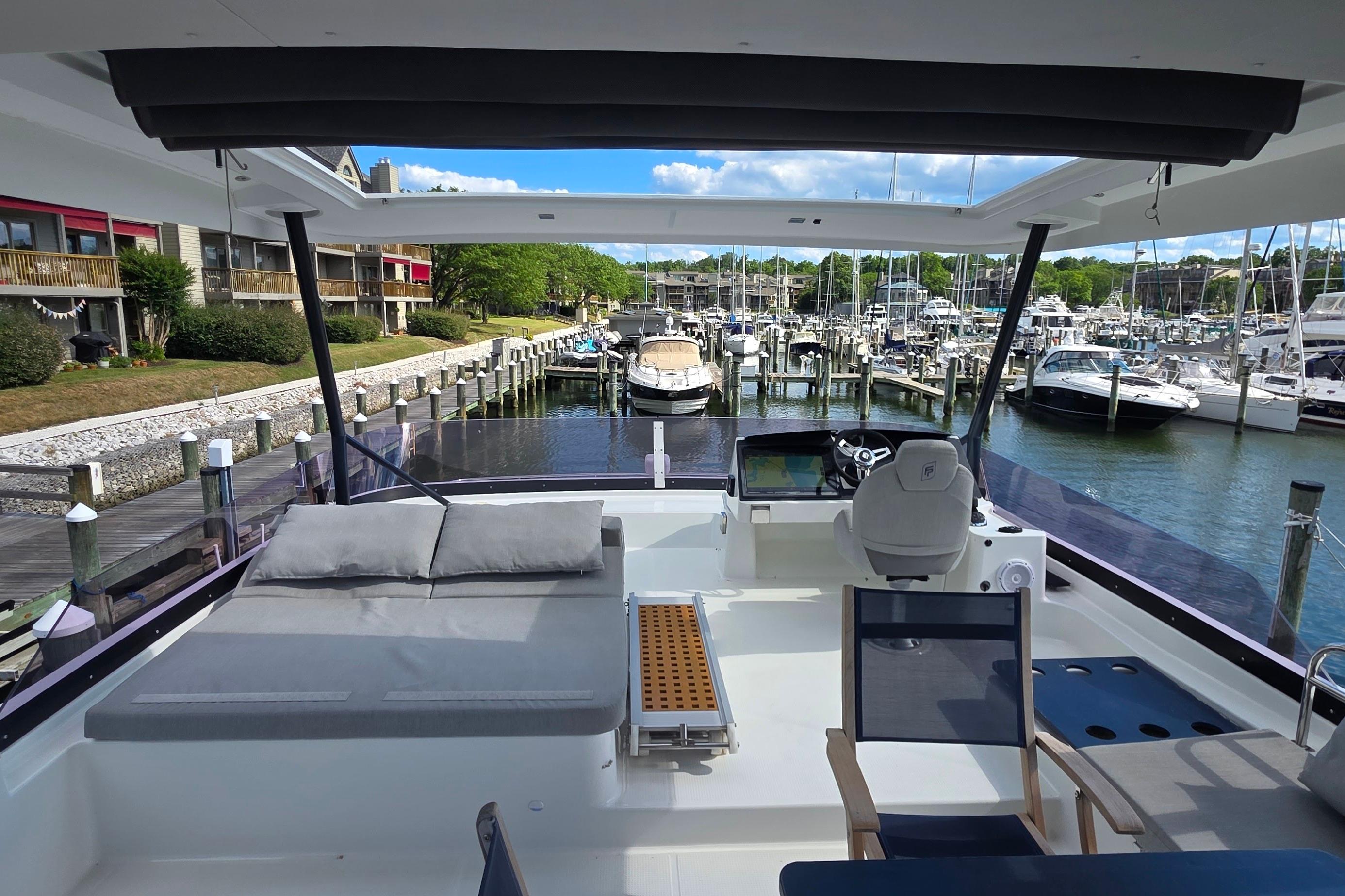Luxurious 2018 Fountaine Pajot Motor Yacht 44 docked at a scenic marina.