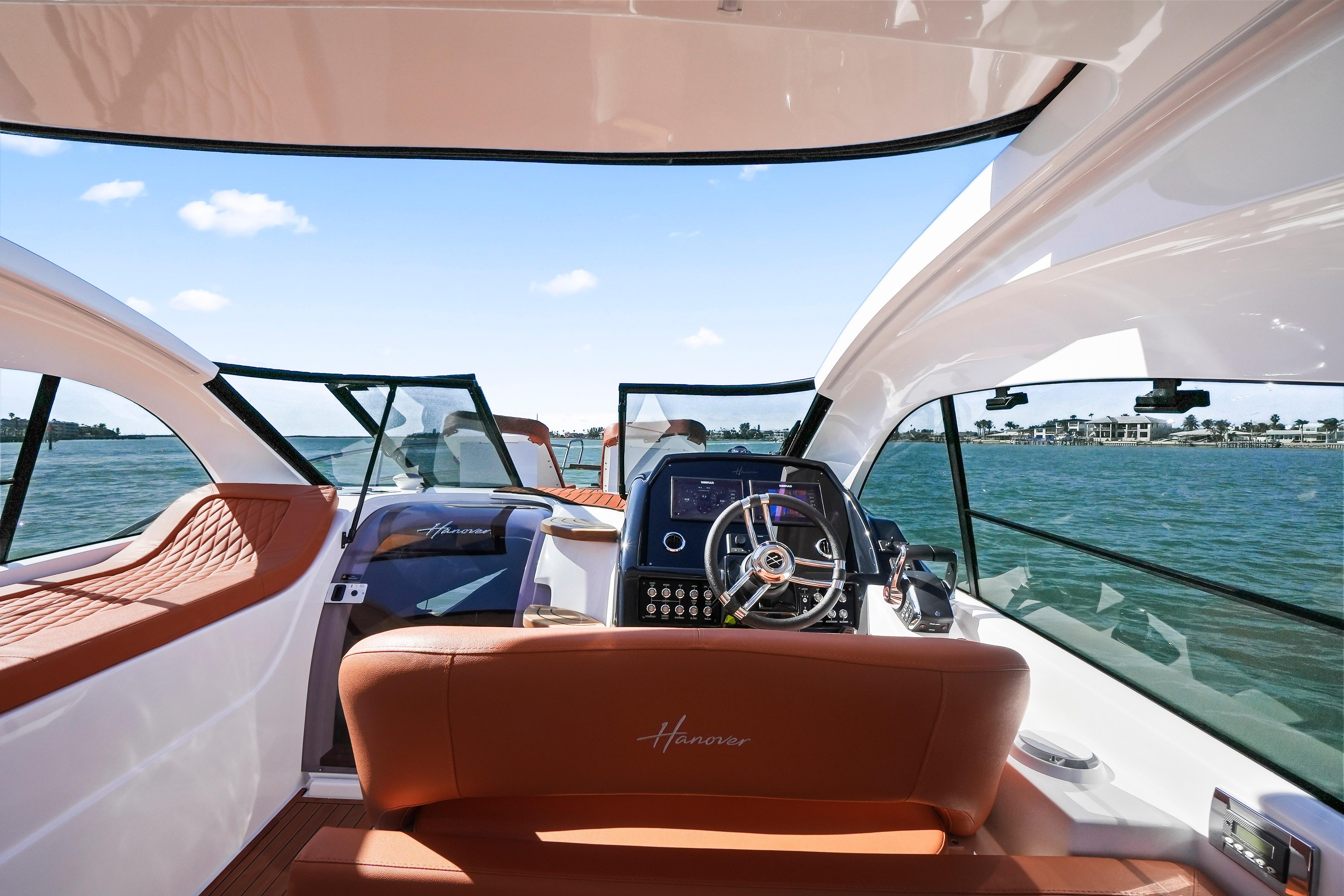 Interior view of 2026 Hanover 355 yacht with luxurious seating and modern dashboard.