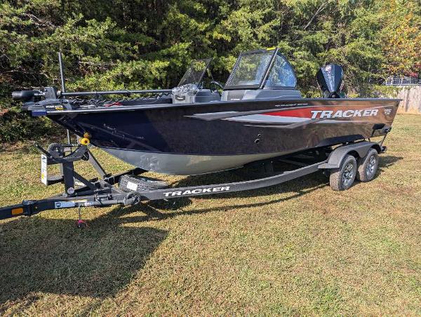 2025 Tracker Targa V-19 WT boat on trailer, parked on grass.
