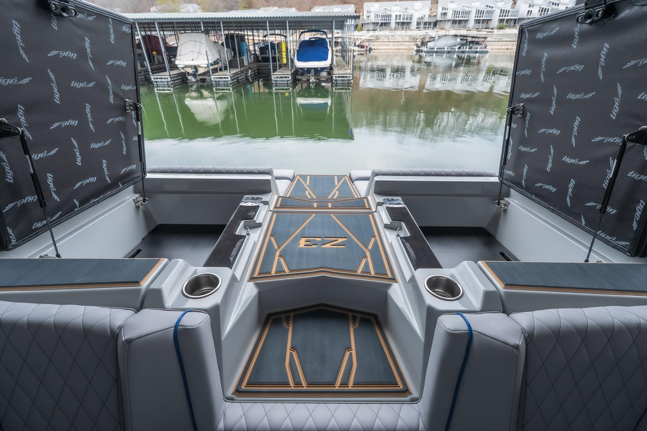 2026 Tigé Z3 boat interior with luxurious seating and storage, docked by a marina.