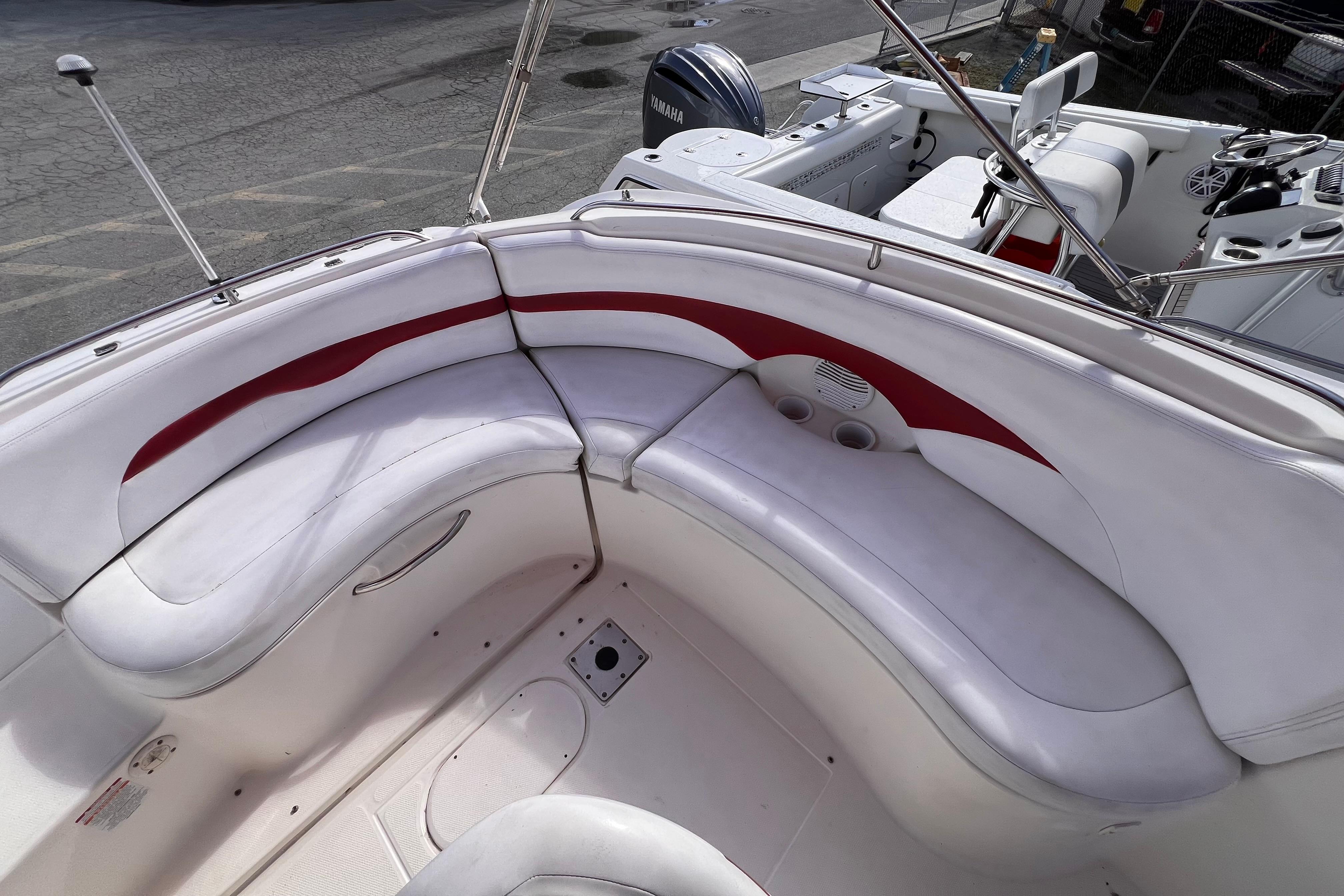 2002 Chaparral 232 Sunesta boat interior with white and red seating.