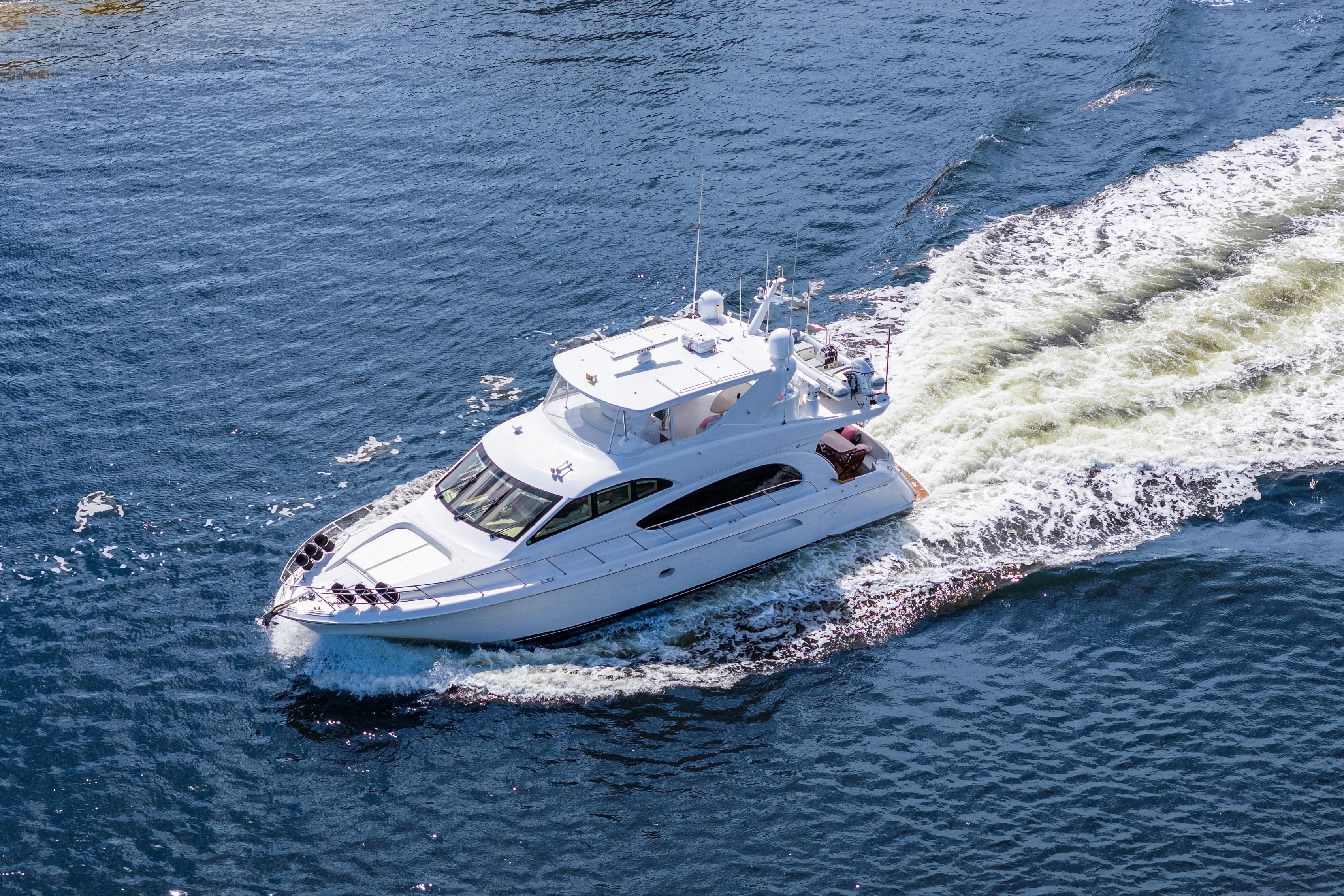 2008 Hatteras 64 Motor Yacht cruising on open water, aerial view.