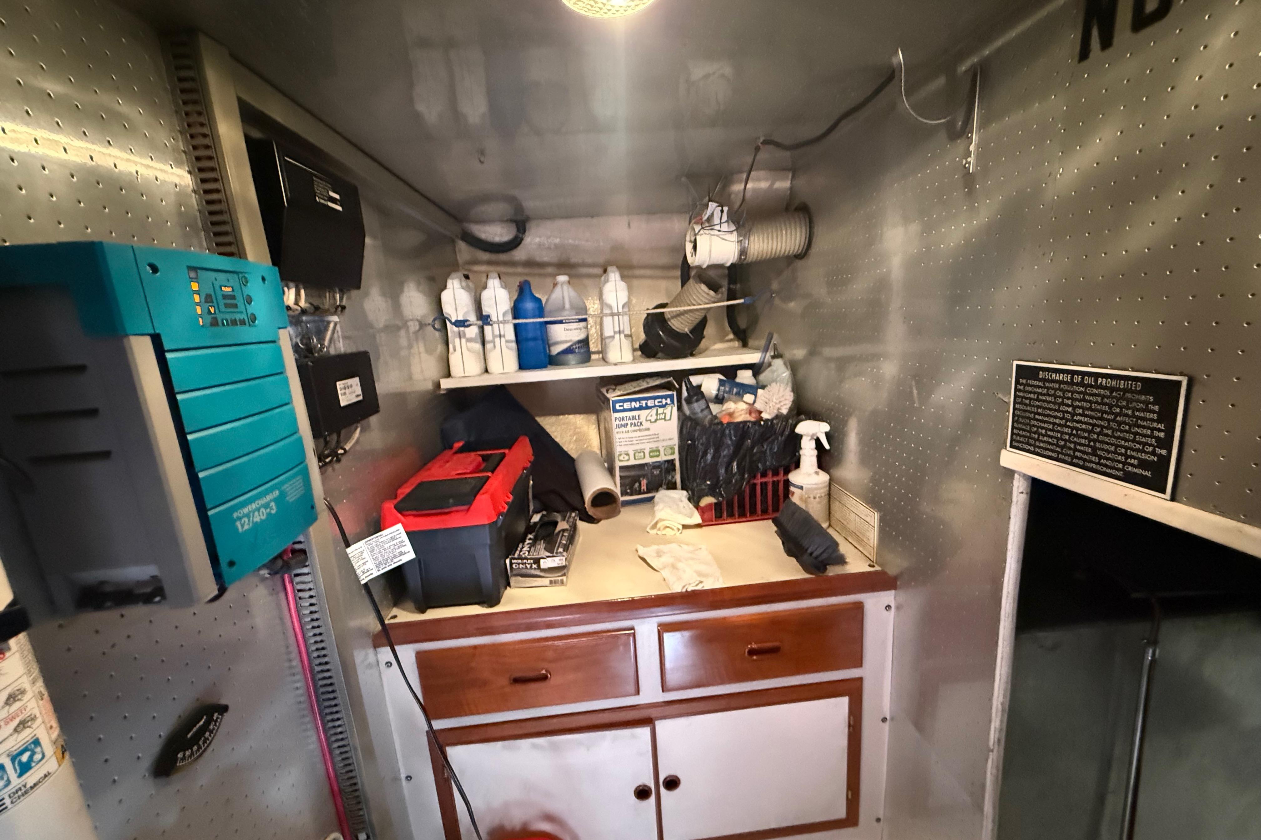 Engine room of a 2001 Kadey-Krogen 39 with tools and maintenance supplies.