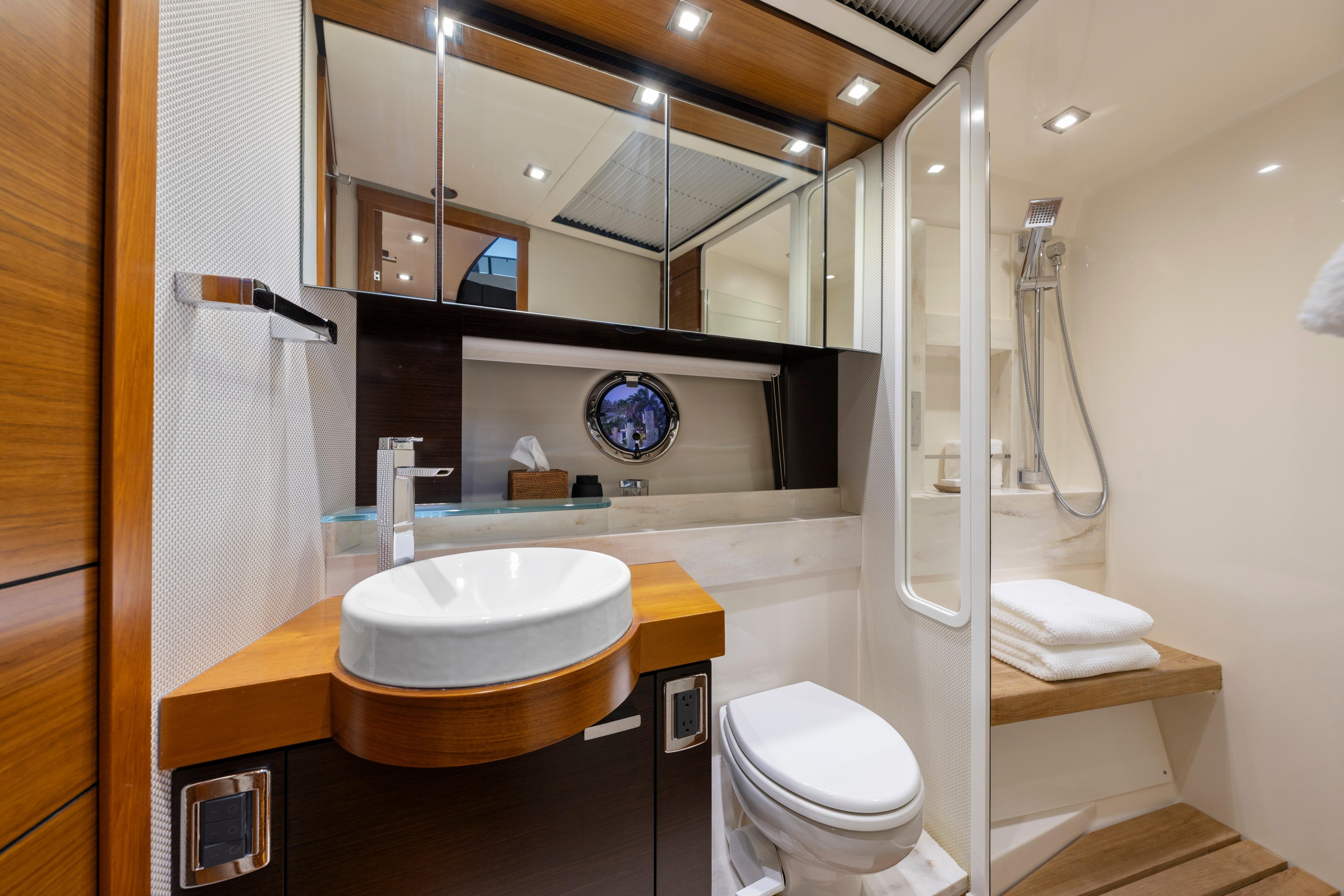 Luxurious 2015 Tiara Yachts bathroom with modern fixtures, wooden accents, and elegant design.
