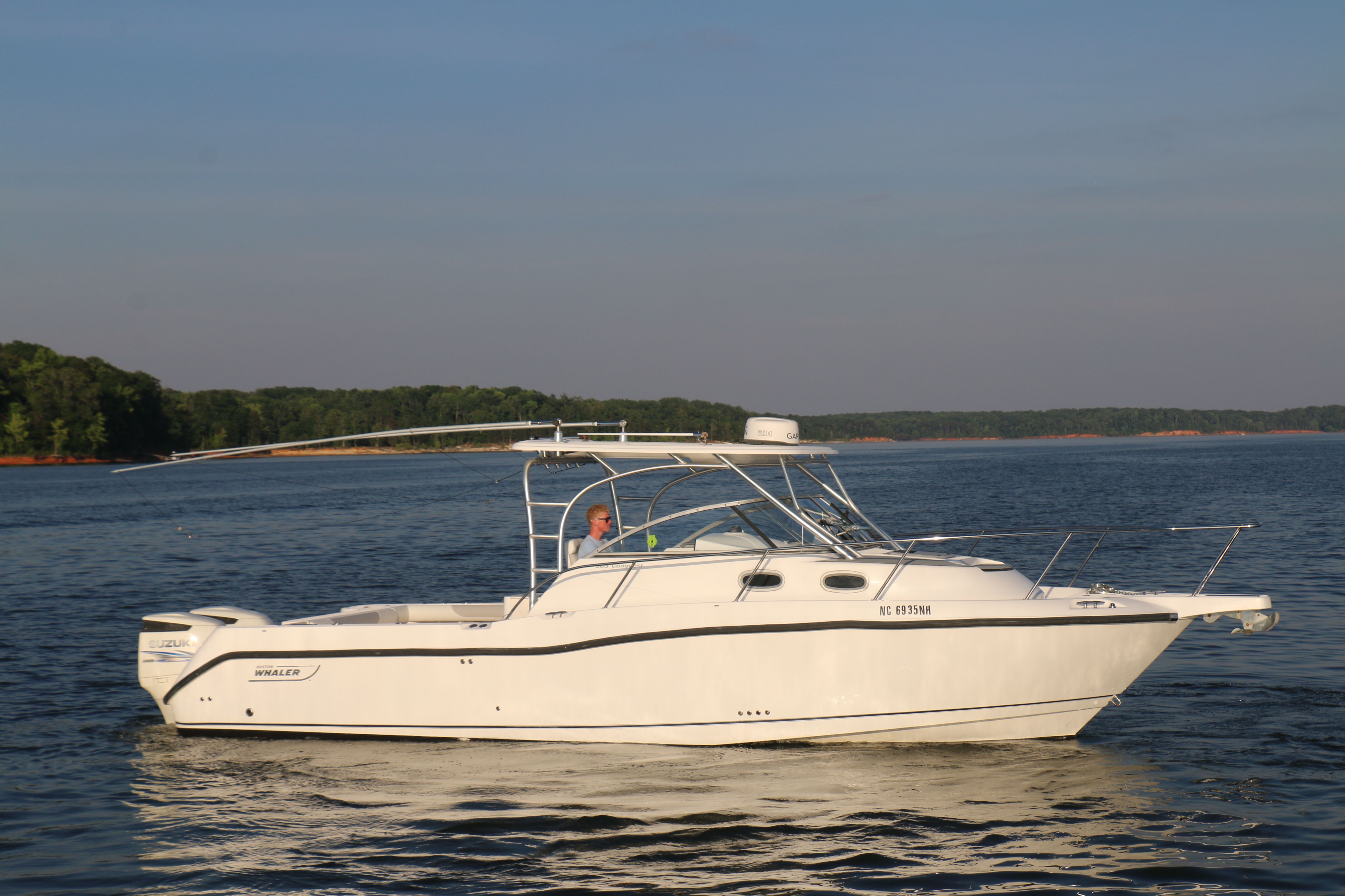 A 2006 Boston Whaler 305 Conquest cruising on calm waters.