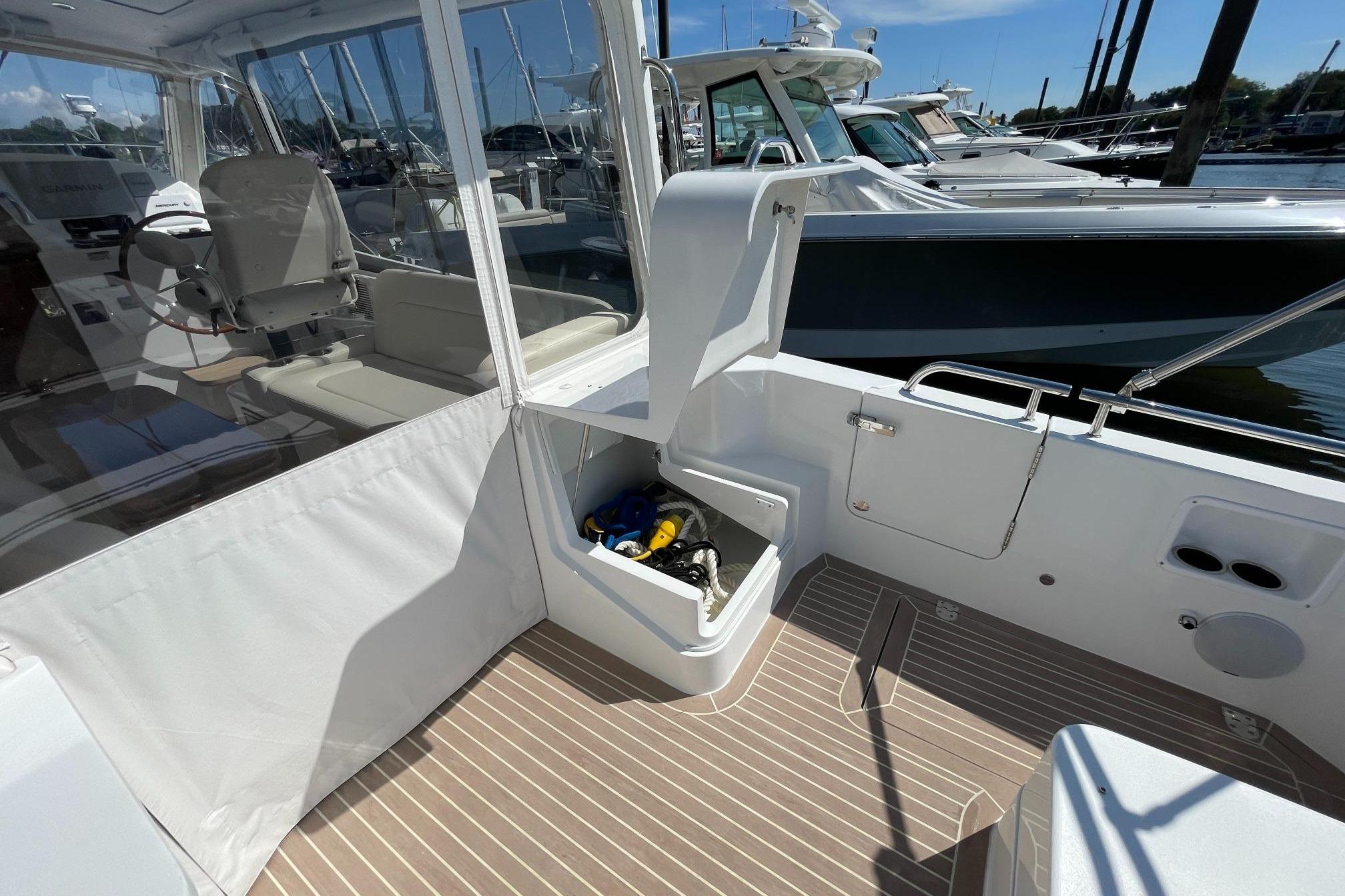 2023 MJM 35 boat interior with open storage compartment and seating area.