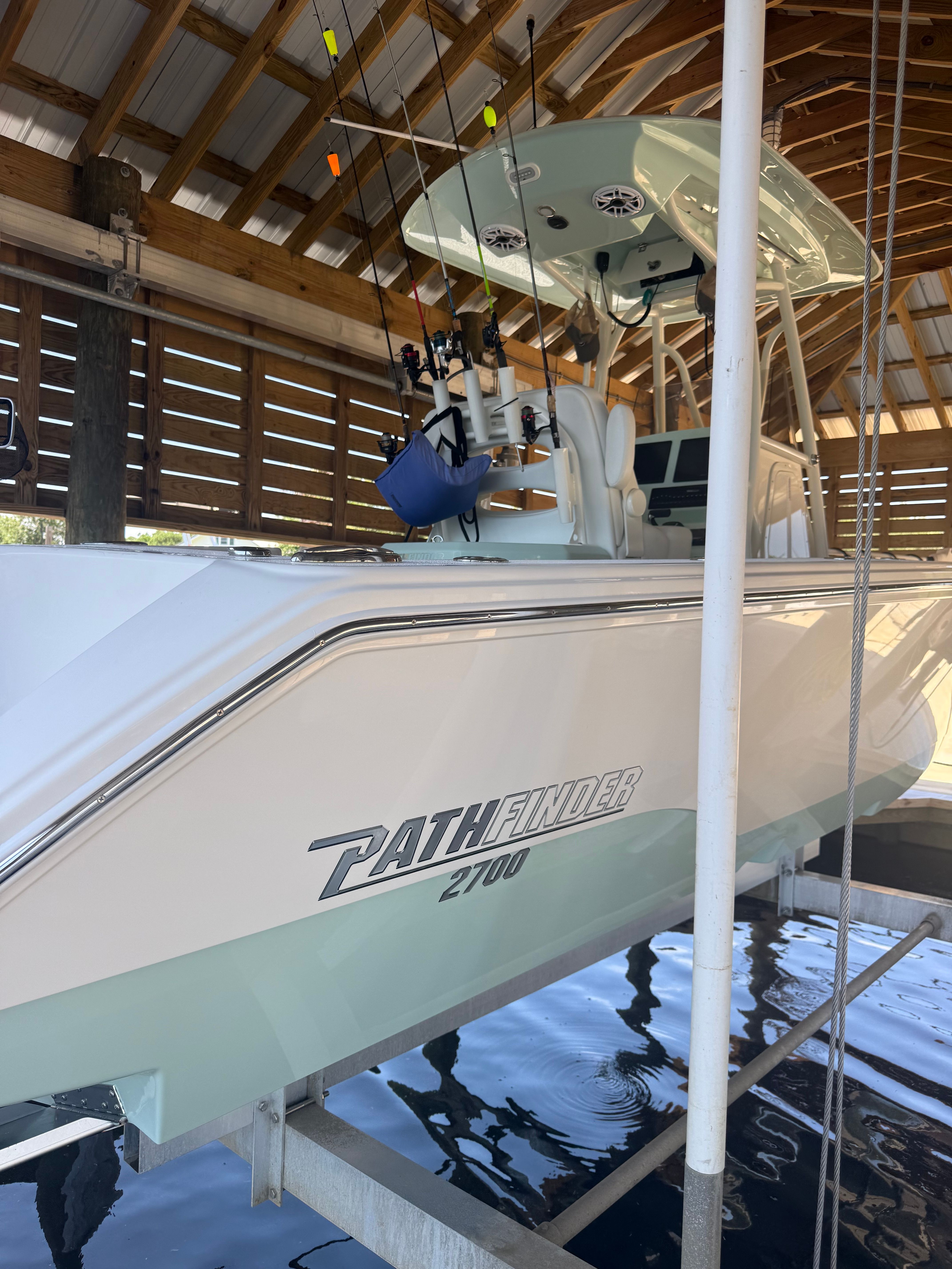 Pathfinder 2700 Open 2024 docked in boathouse.