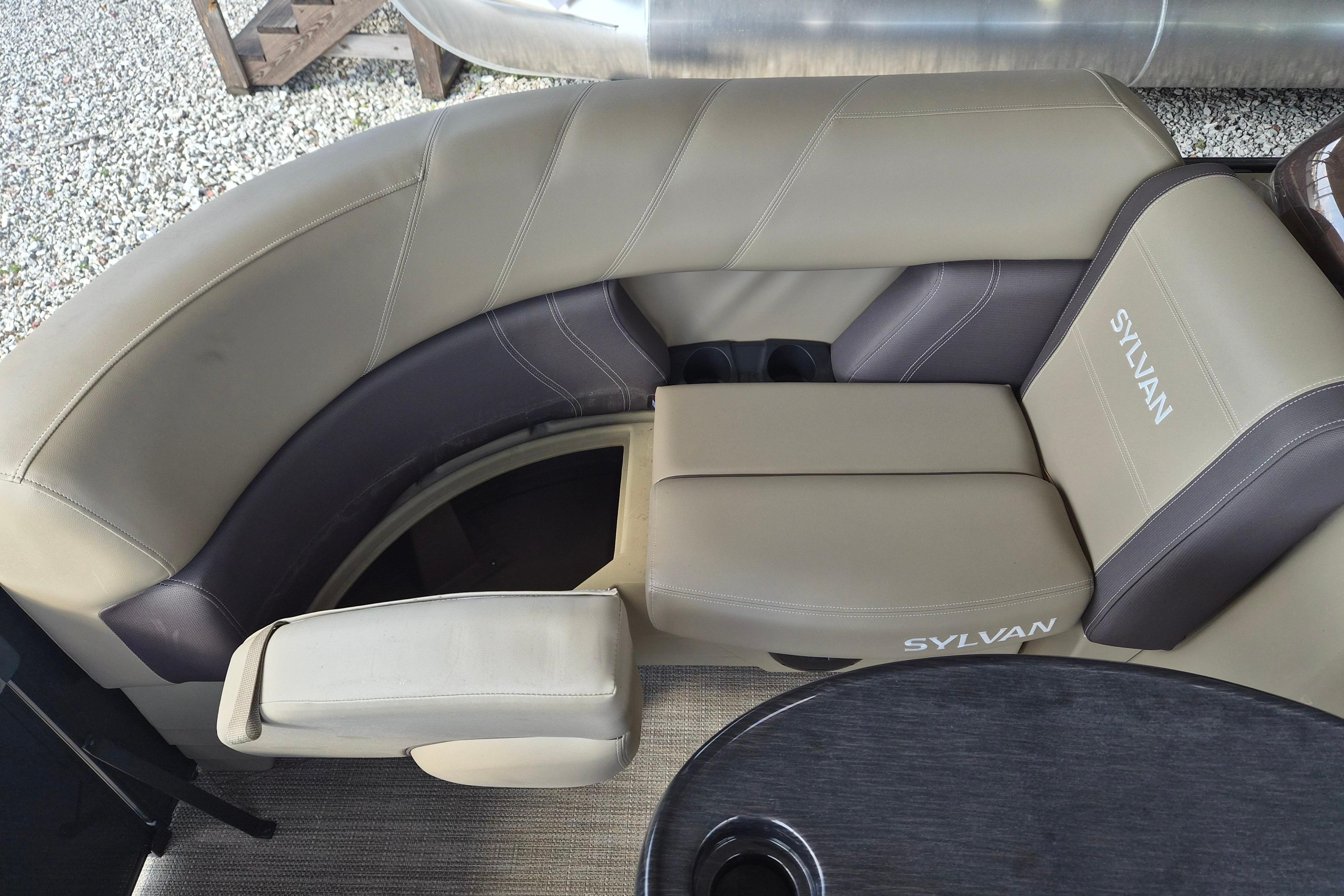 Luxurious seating on 2026 Sylvan Mirage 820 CLZ DH pontoon boat, featuring beige and brown upholstery.