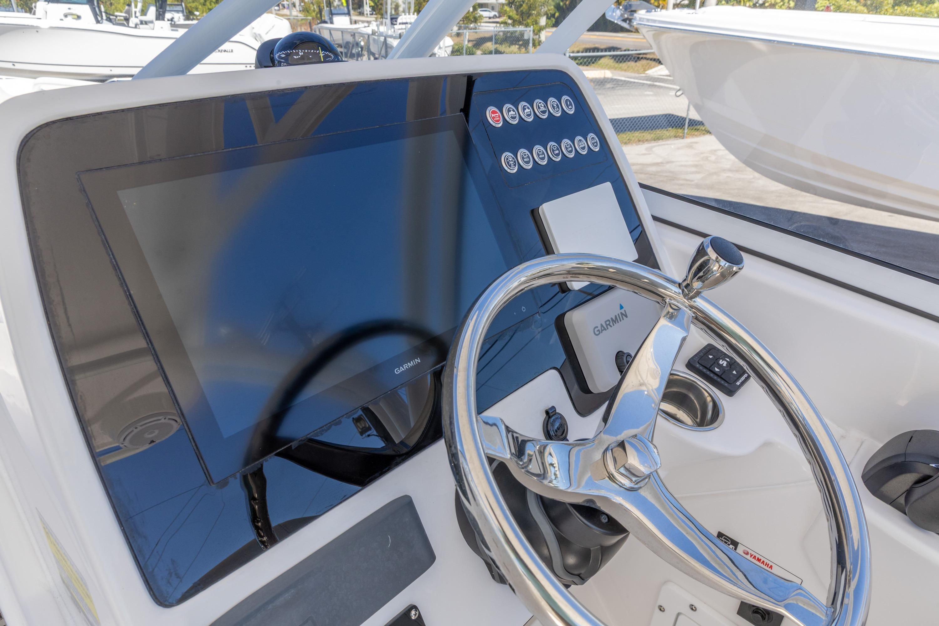 2026 Edgewater 248CX Crossover boat dashboard with Garmin display and steering wheel.